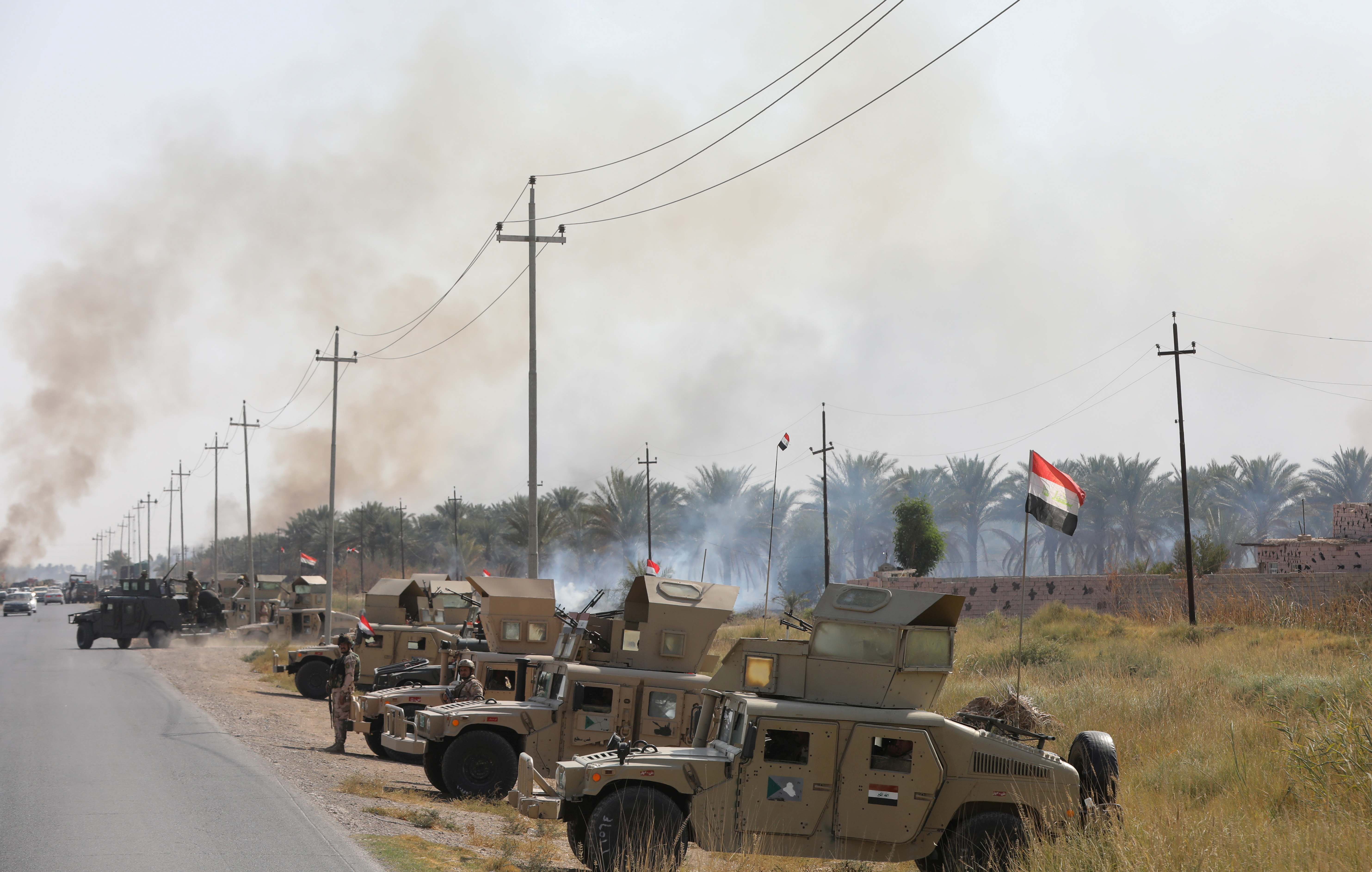 Military vehicles of Iraqi security forces are seen after an attack by Islamic State militants, near Muqdadiya