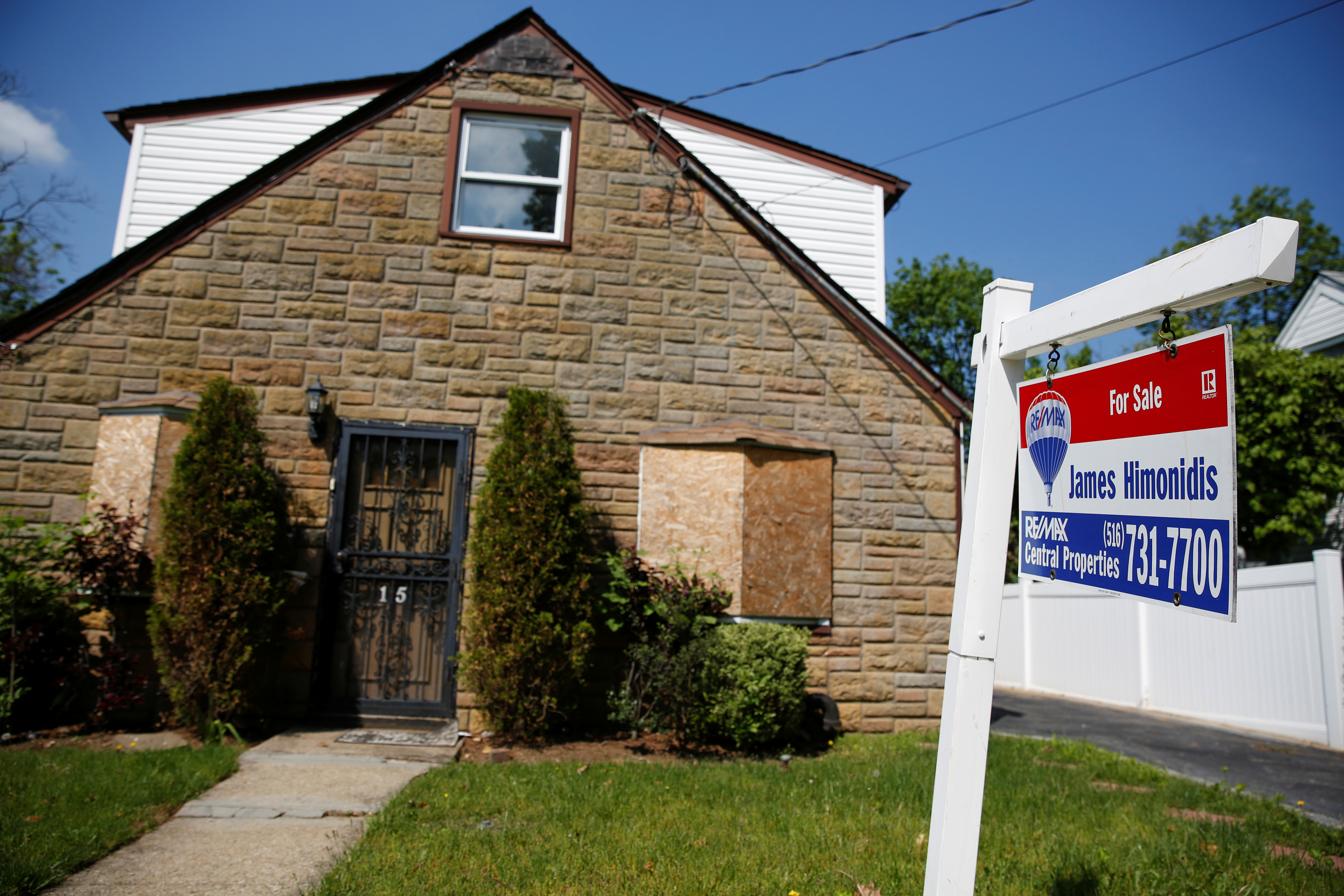 A 'for sale' is seen outside a single family house in Garden City New York