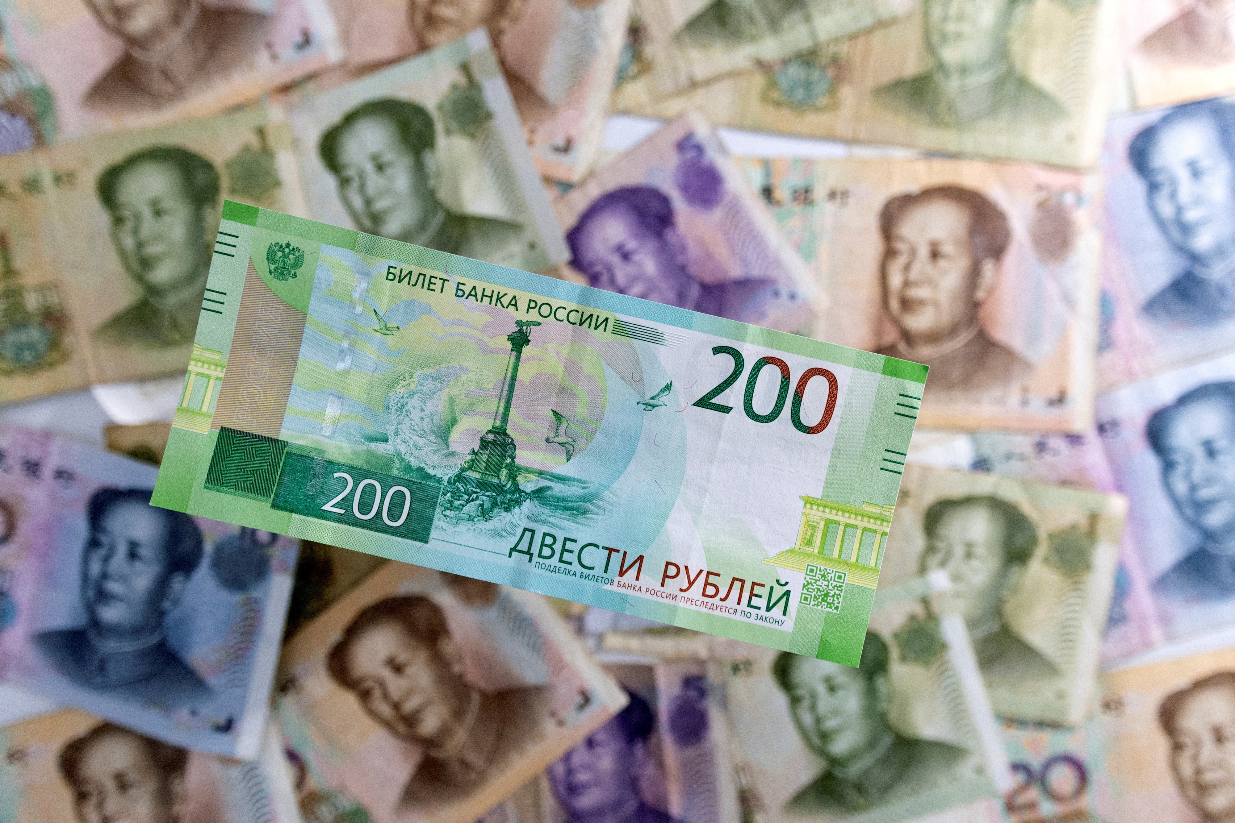 Illustration shows Russian Rouble and Chinese Yuan banknotes