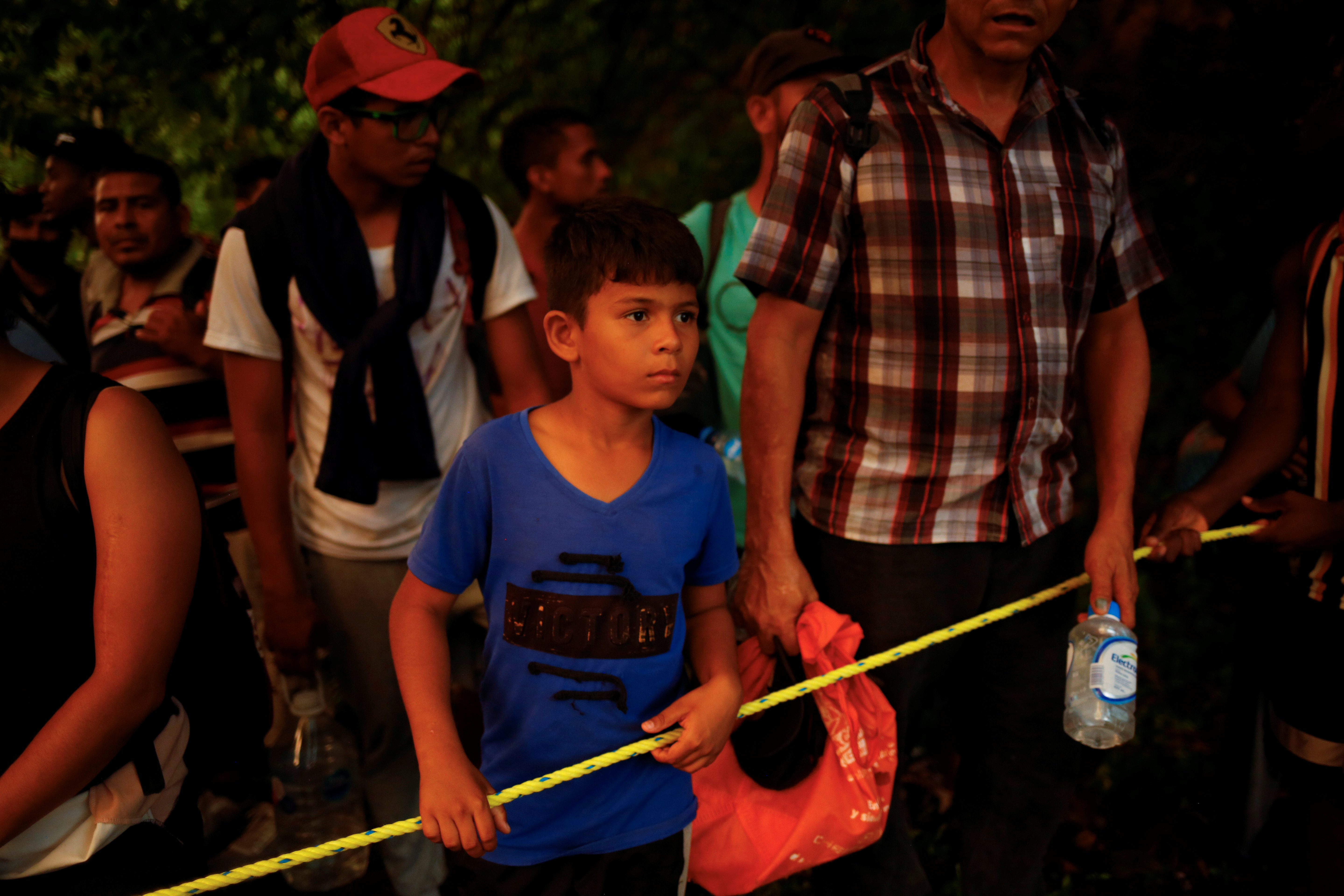 Xabiel, 9, a migrant from Venezuela traveling with his brother joins the caravan heading to the U.S. border, near Villa Comaltitlan, Mexico November 20, 2021. REUTERS/Jose Luis Gonzalez