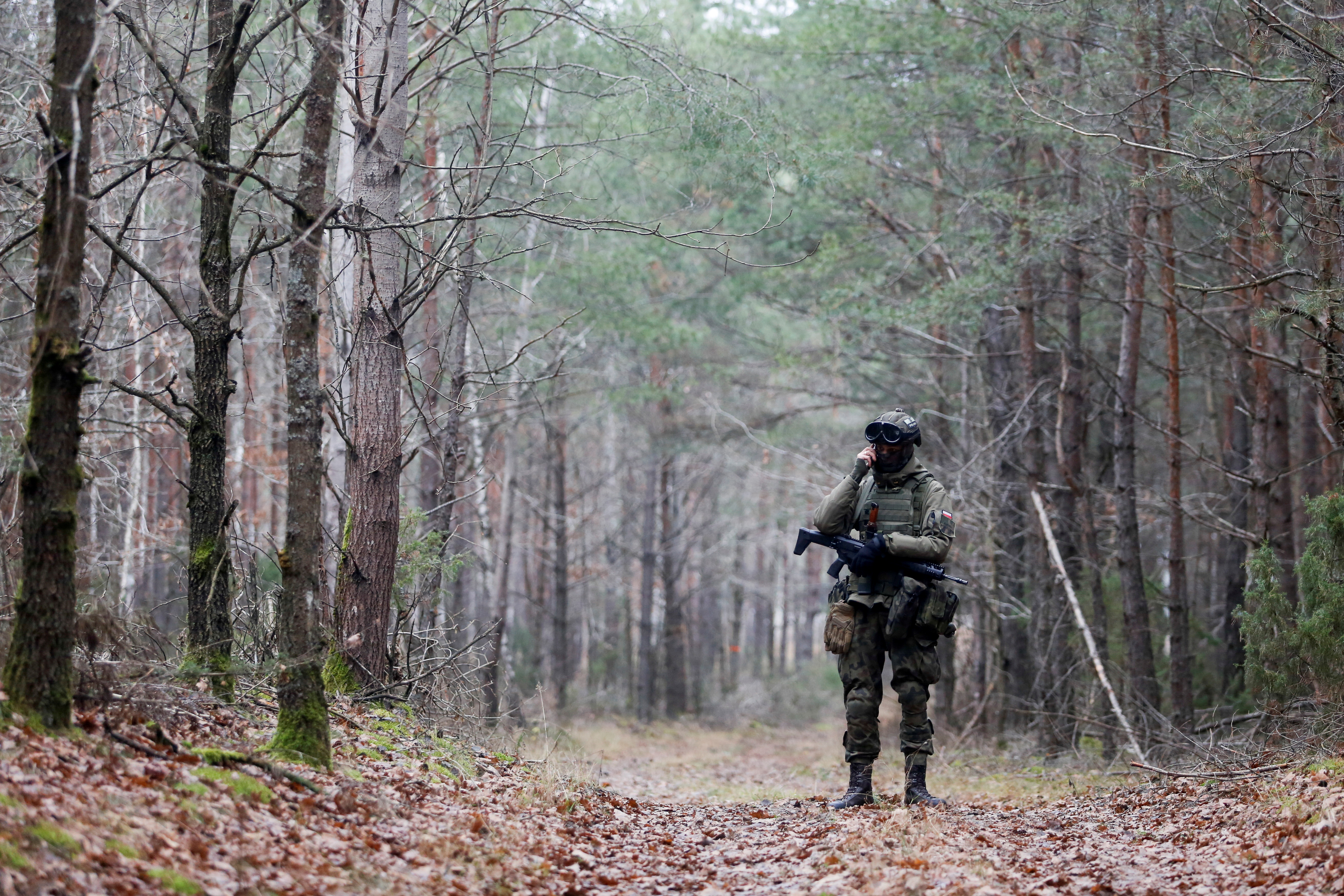 A military stands guard in the woods, close to the Milejczyce village, Poland, November 26 2021. REUTERS/Lukasz Glowala/File Photo