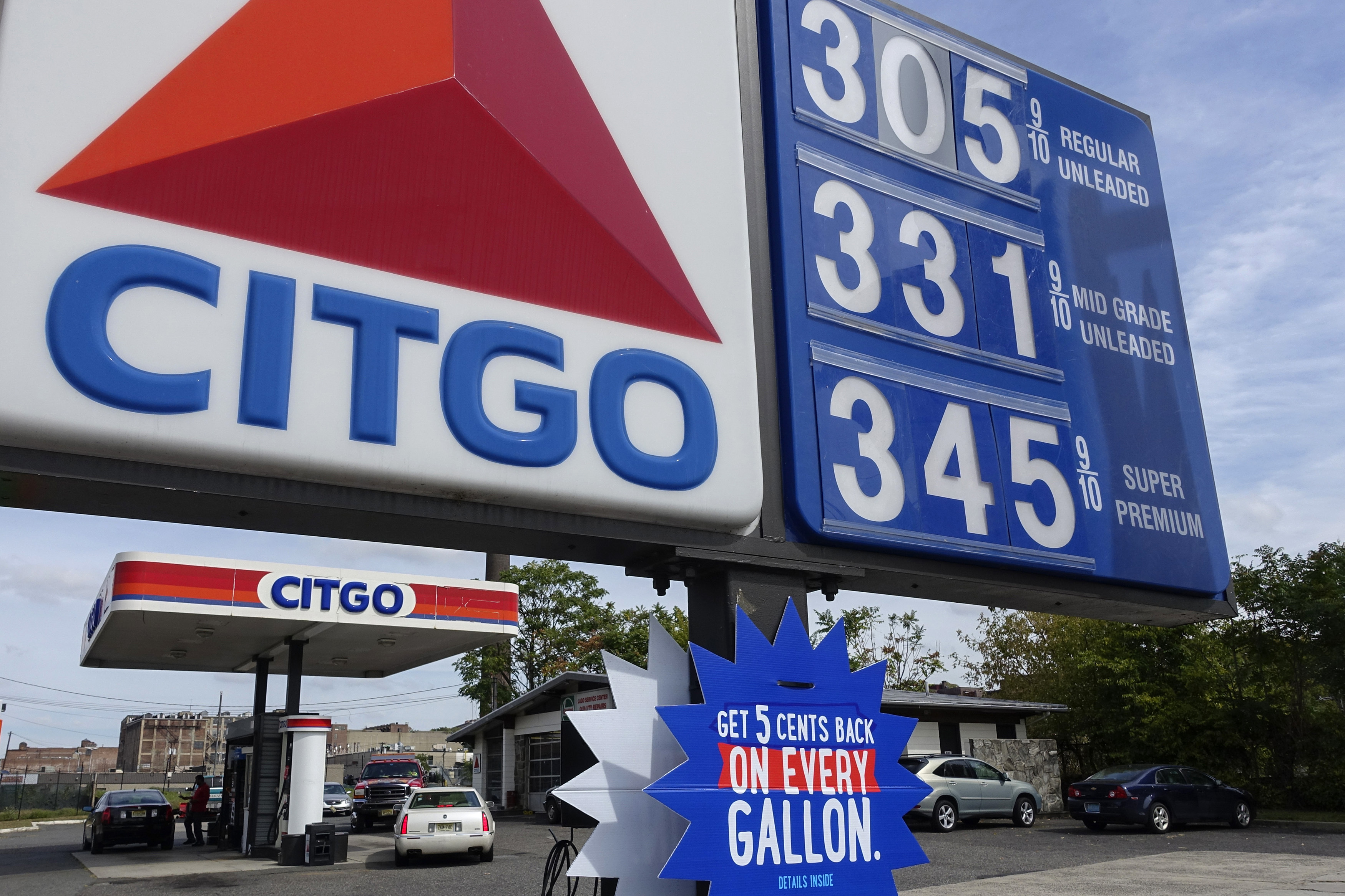 People fuel their cars at a Citgo gas station in Kearny, New Jersey