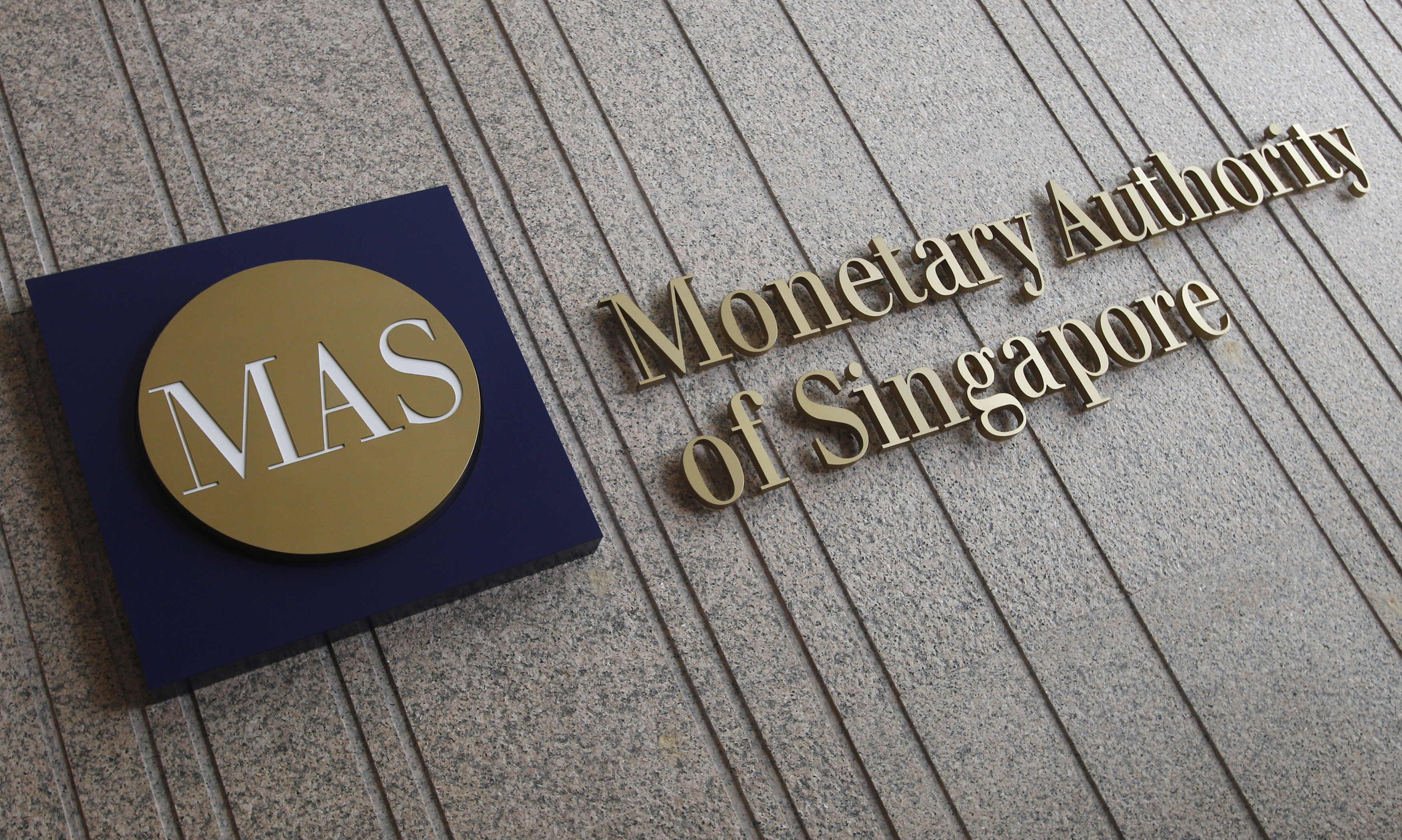 The logo of the Monetary Authority of Singapore is pictured at its building in Singapore