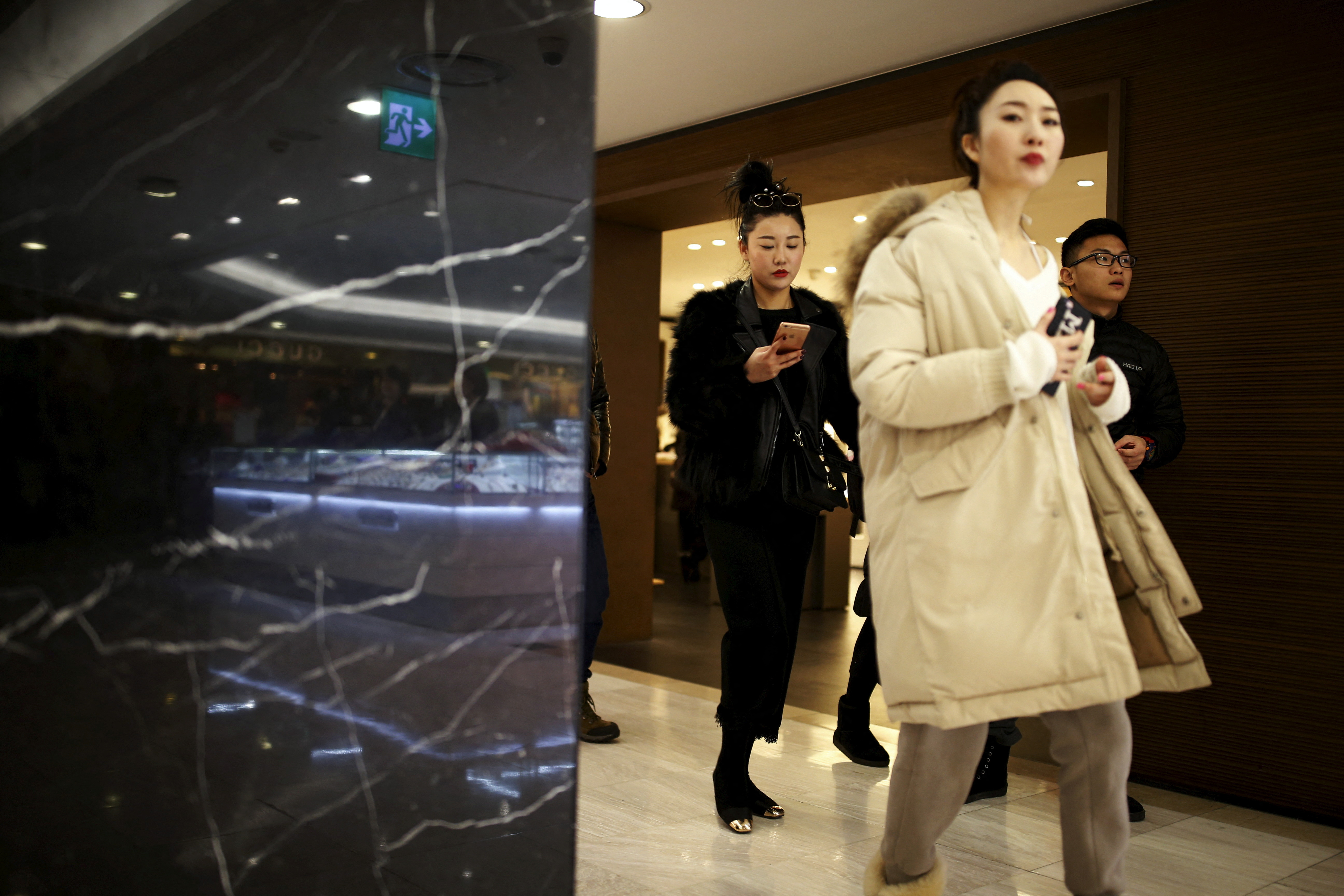 Chinese tourists shop at a Lotte duty free shop in central Seoul