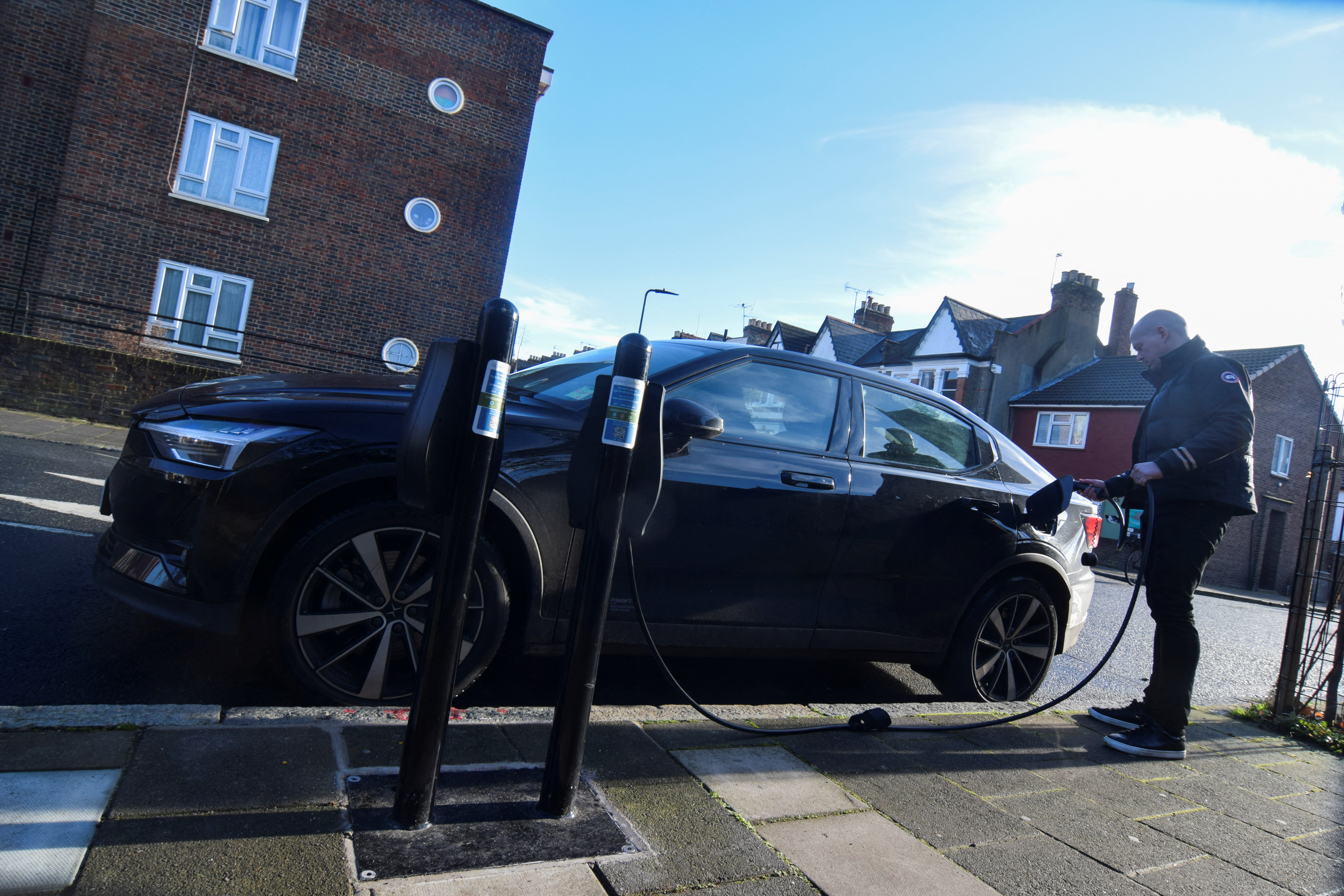 Connected Kerb CEO Chris Pateman-Jones plugs his electric vehicle into one of the charging infrastructure company's smart public on-street chargers in the borough of Hackney, London