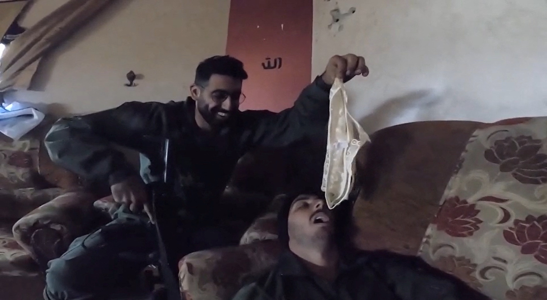 An Israeli soldier holds underwear over the face of a fellow Israeli soldier in a screengrab from a video