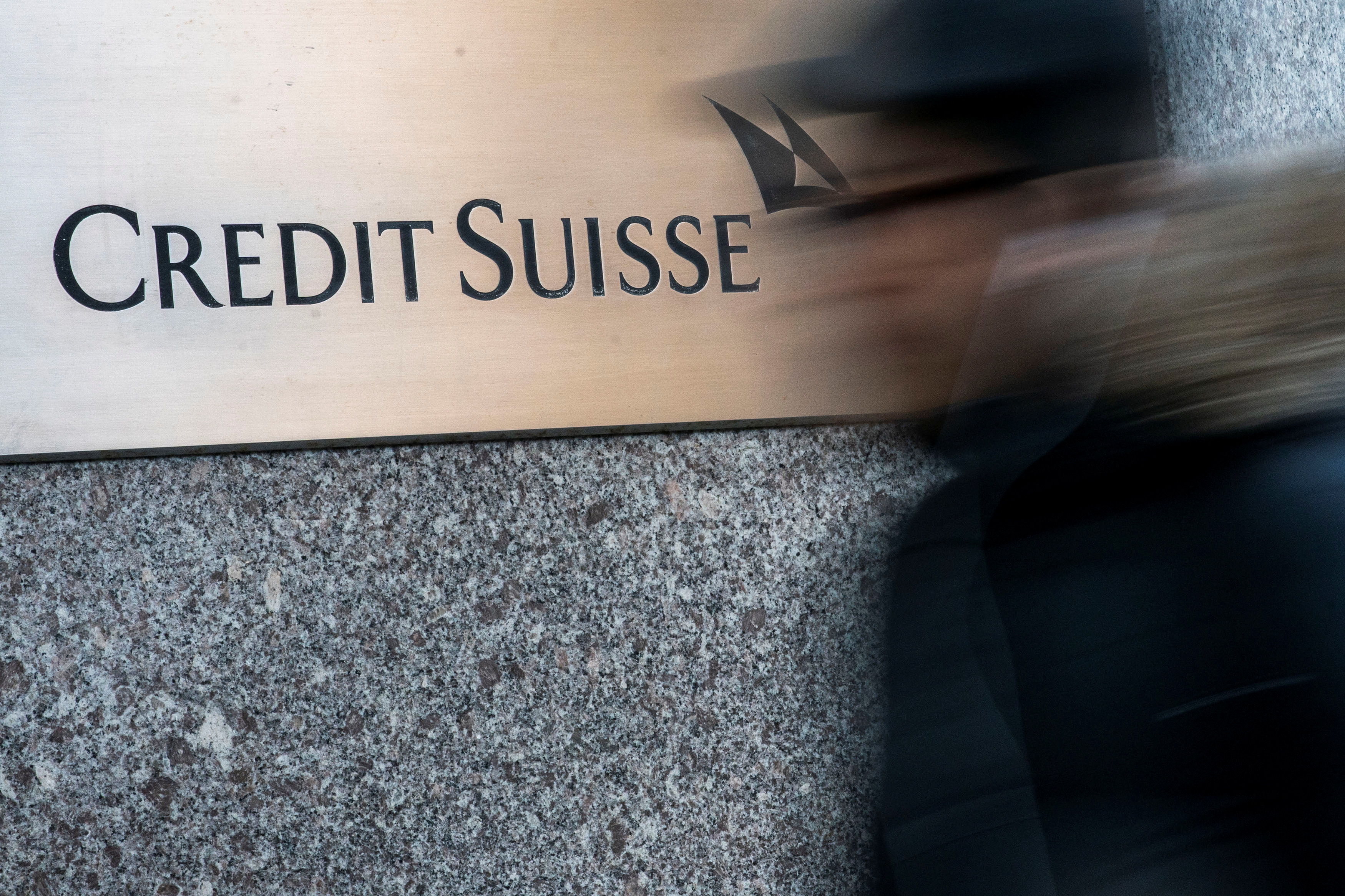 A man walks near Credit Suisse bank headquarters in New York