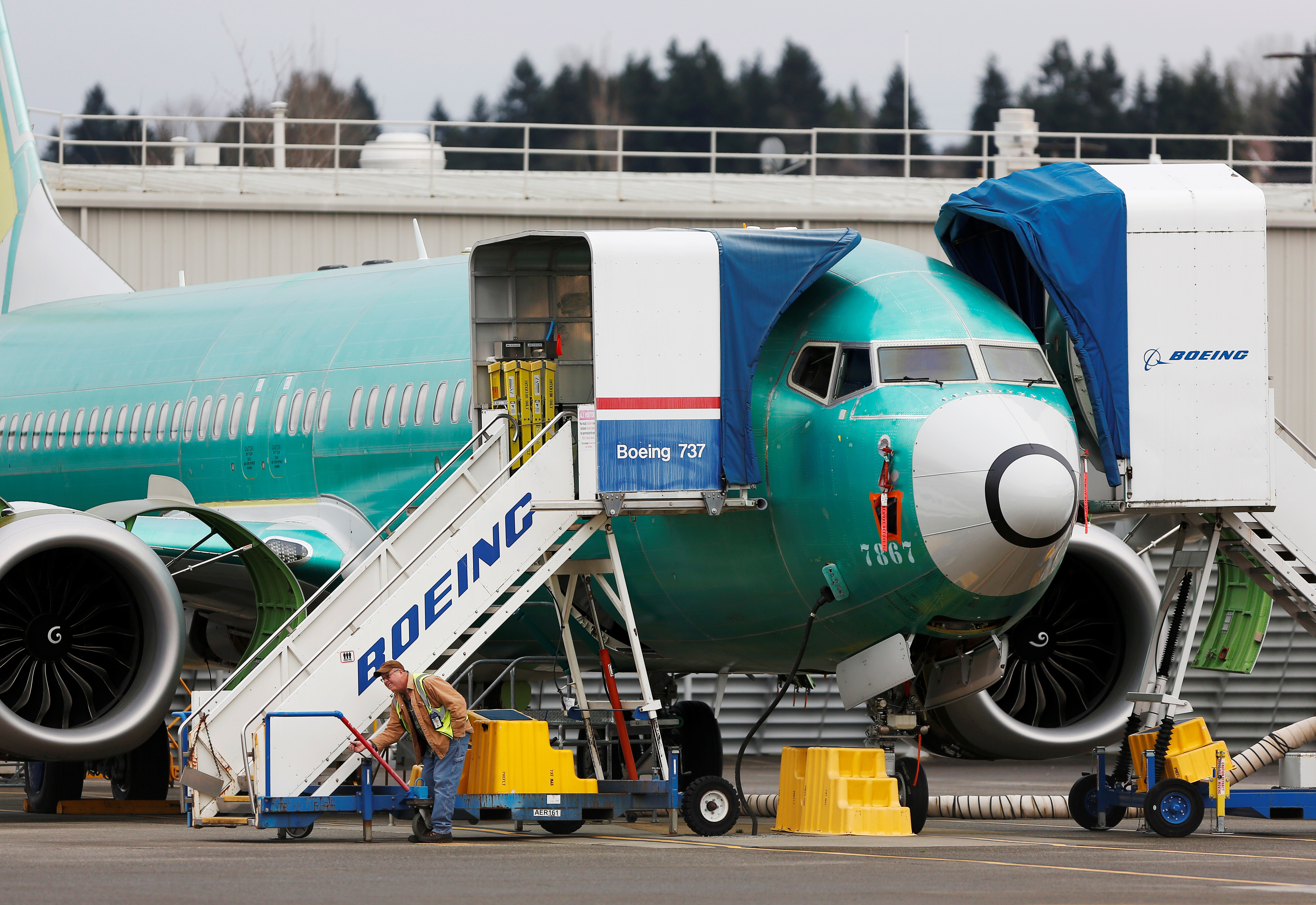 An employee works near a Boeing 737 Max aircraft at Boeing's 737 Max production facility in Renton