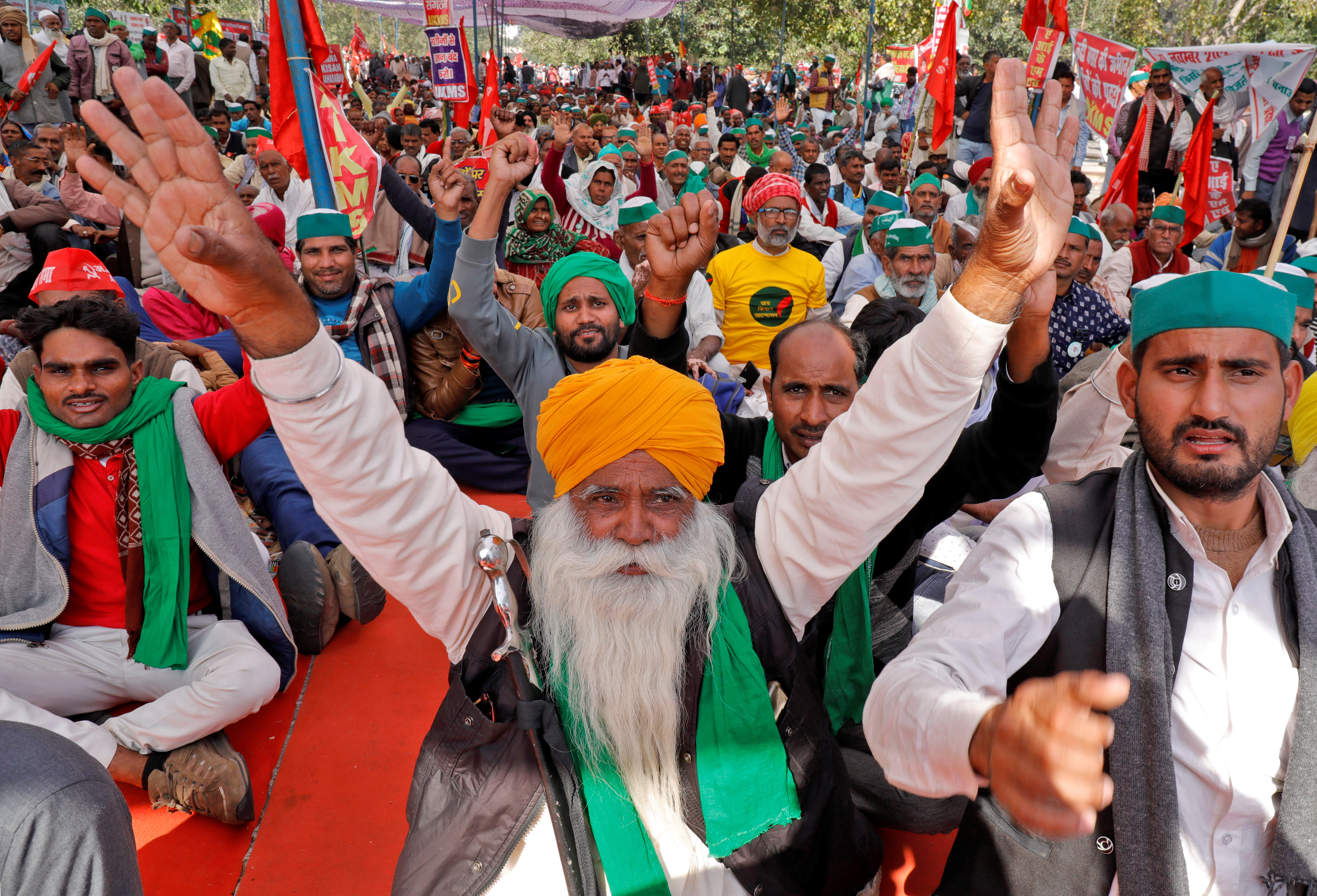 Farmers shout slogans during a mass rally to demand minimum support prices be extended to all produce, in Lucknow