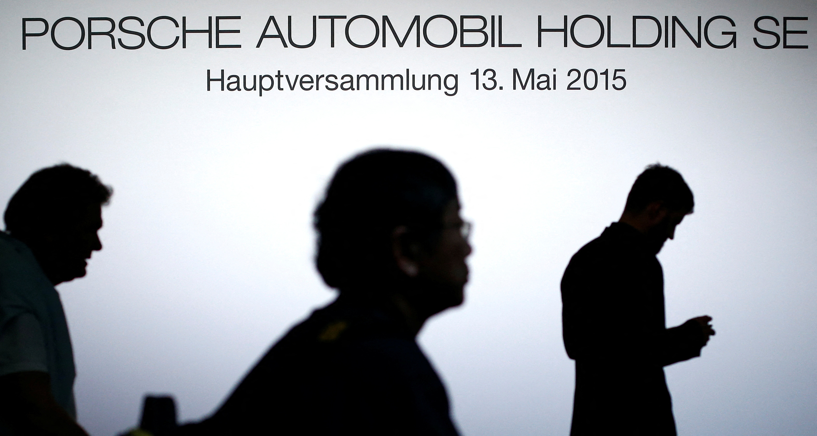 People are silhouetted at the Porsche annual meeting in Stuttgard