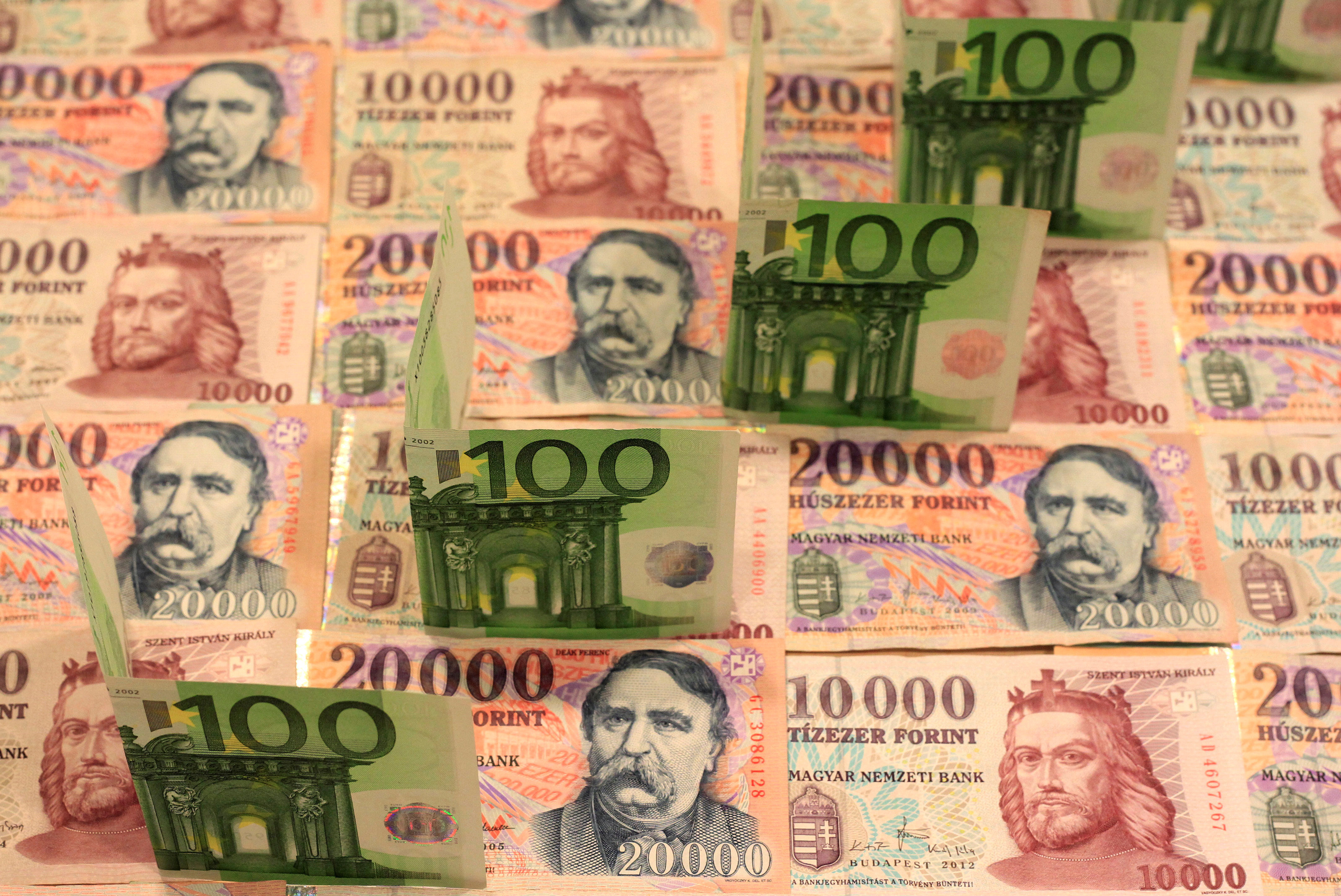 100 Euro banknotes are seen on top of Hungarian forint banknotes of various denominations in this illustration picture