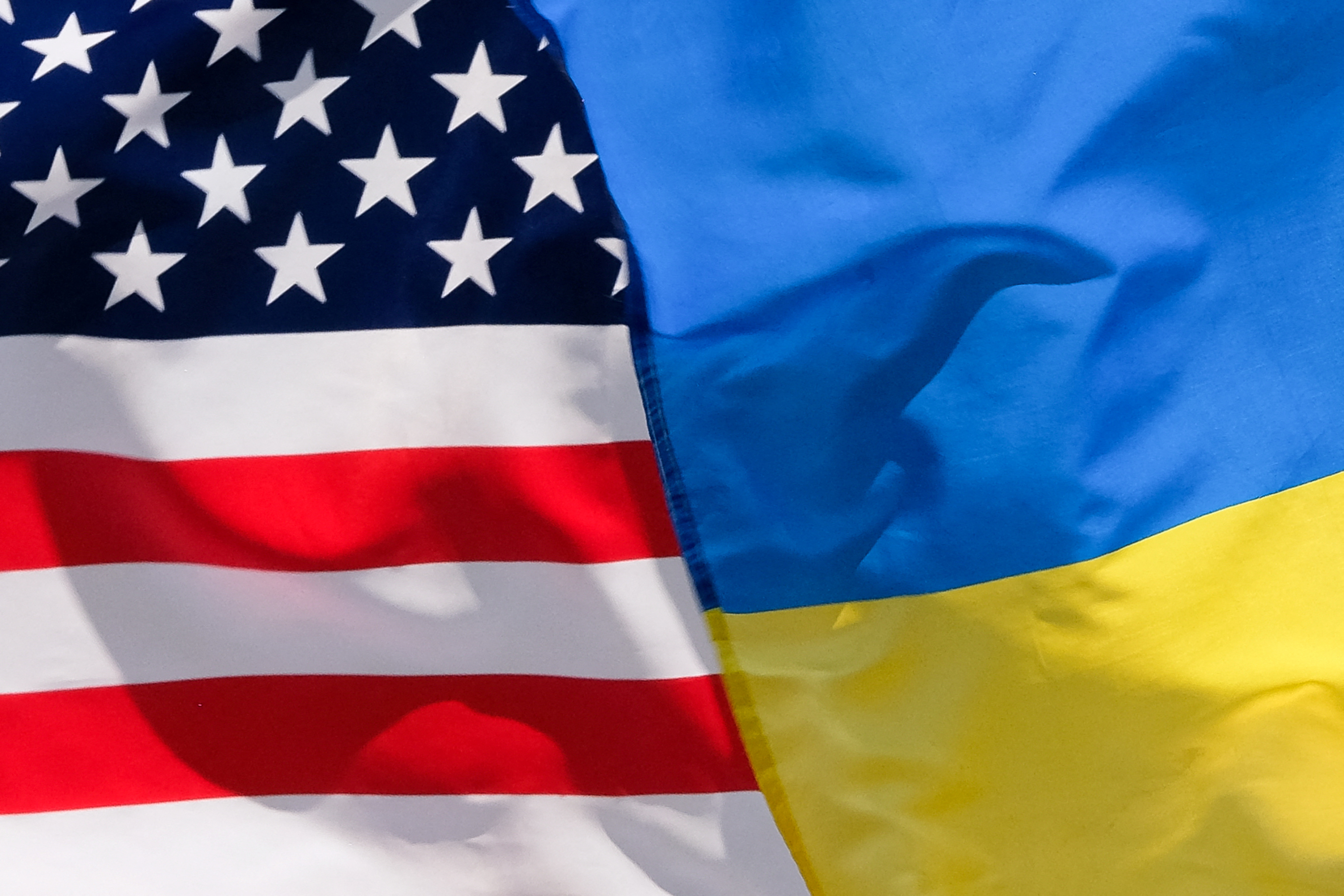 The American and Ukrainian flags wave next to each other.