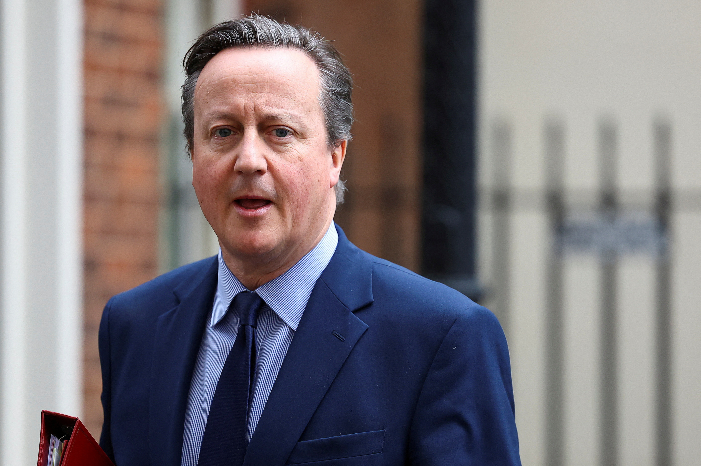 British Foreign Secretary David Cameron walks at Downing Street in London