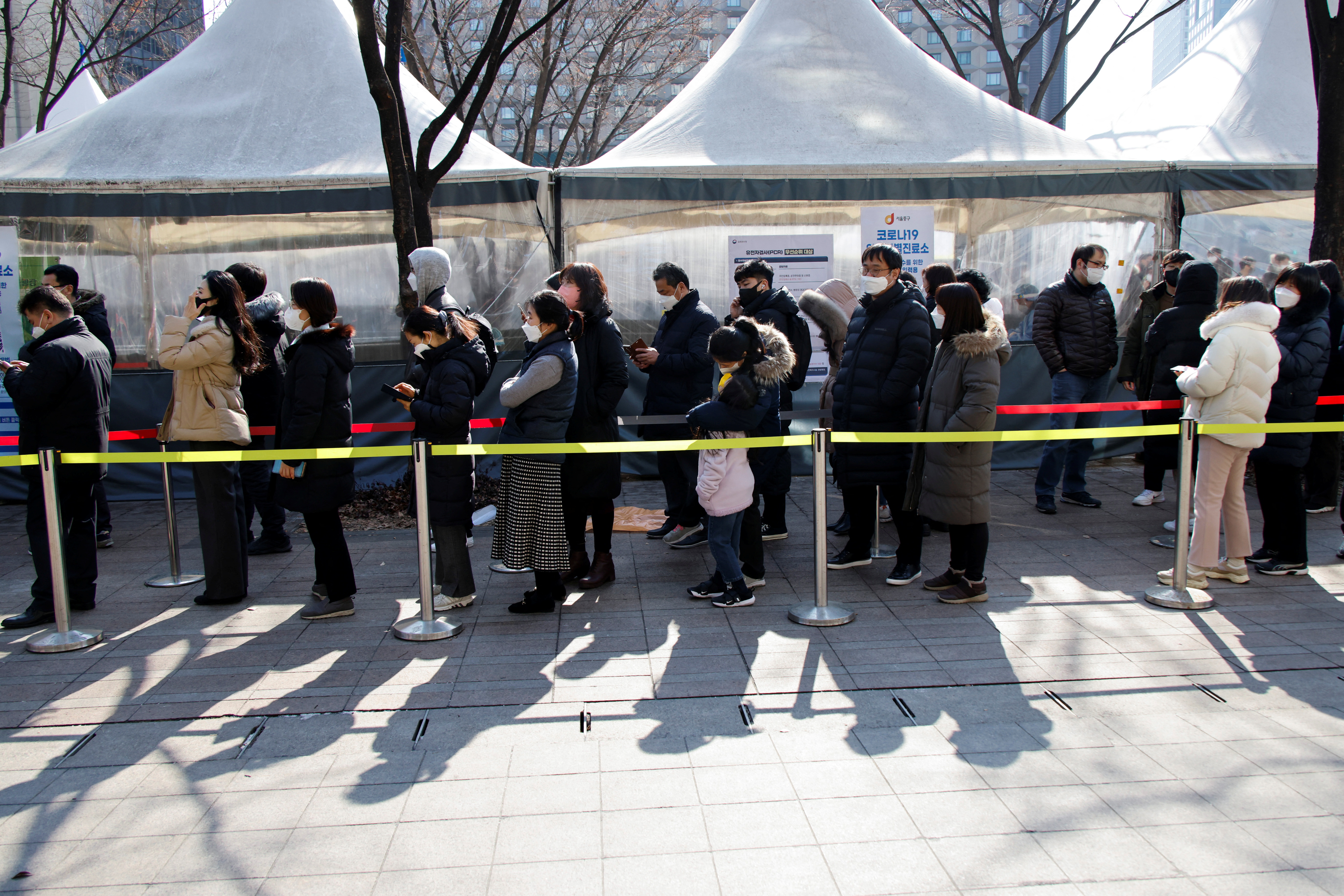 People wait in line to undergo the COVID-19 test in Seoul