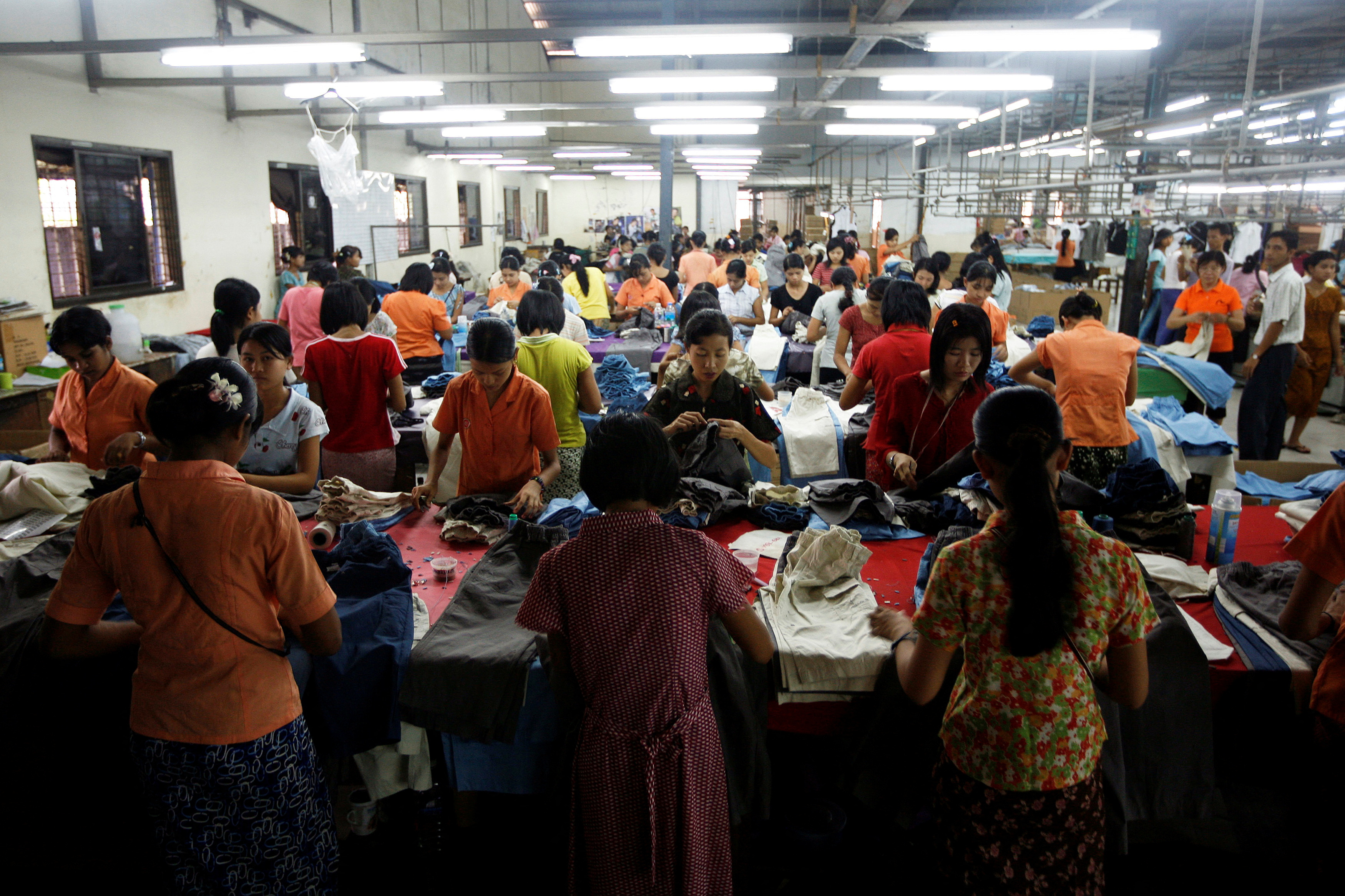 Workers tailor and arrange clothing at a garment factory at Hlaing Tar Yar industry zone in Yangon
