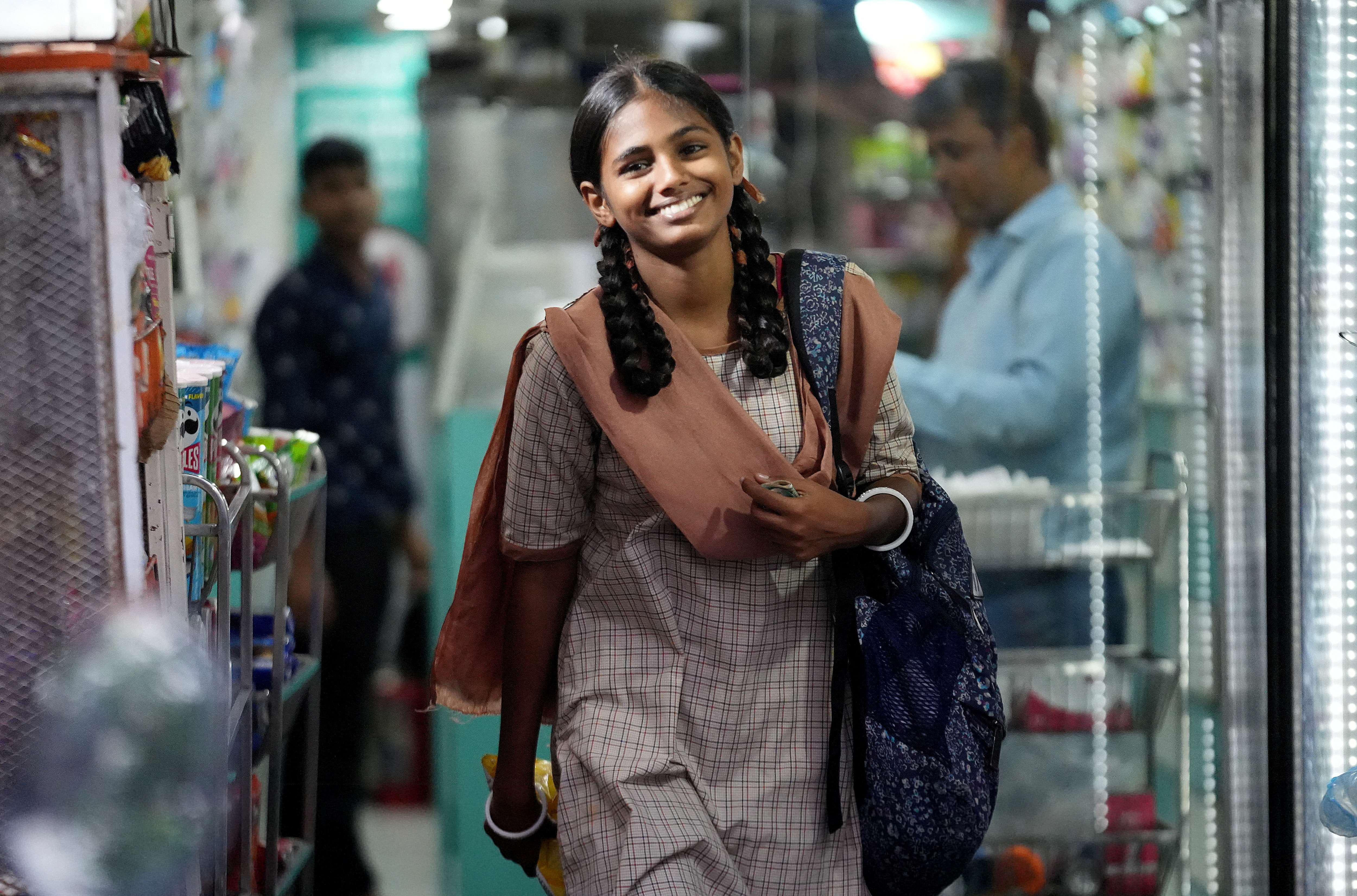 Maleesha Kharwa reacts as she leaves a grocery store in Mumbai