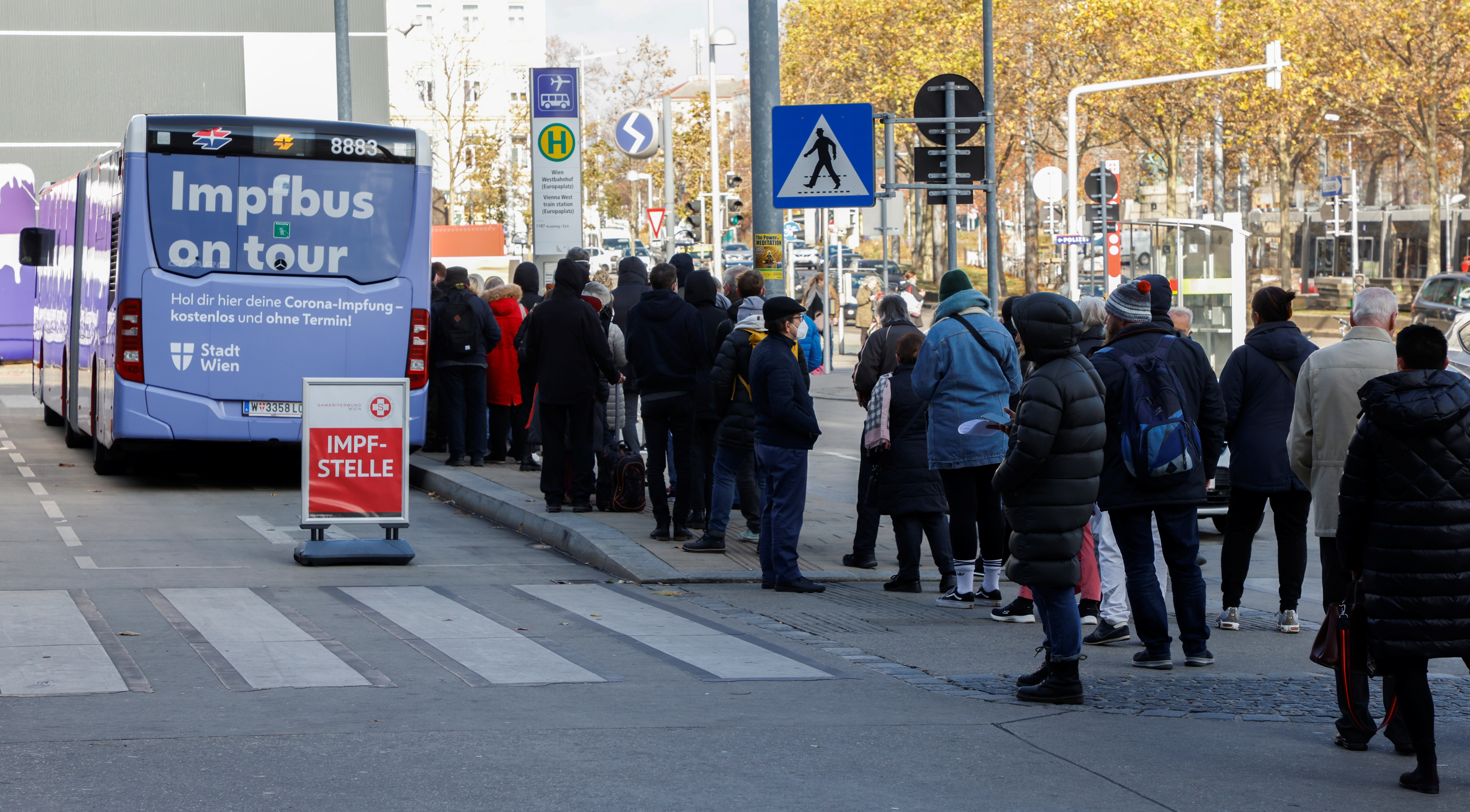 People wait in front of a vaccination bus during the coronavirus disease (COVID-19) outbreak, as Austria's government has imposed a lockdown on people who are not fully vaccinated, in Vienna, Austria, November 18, 2021. REUTERS/Leonhard Foeger