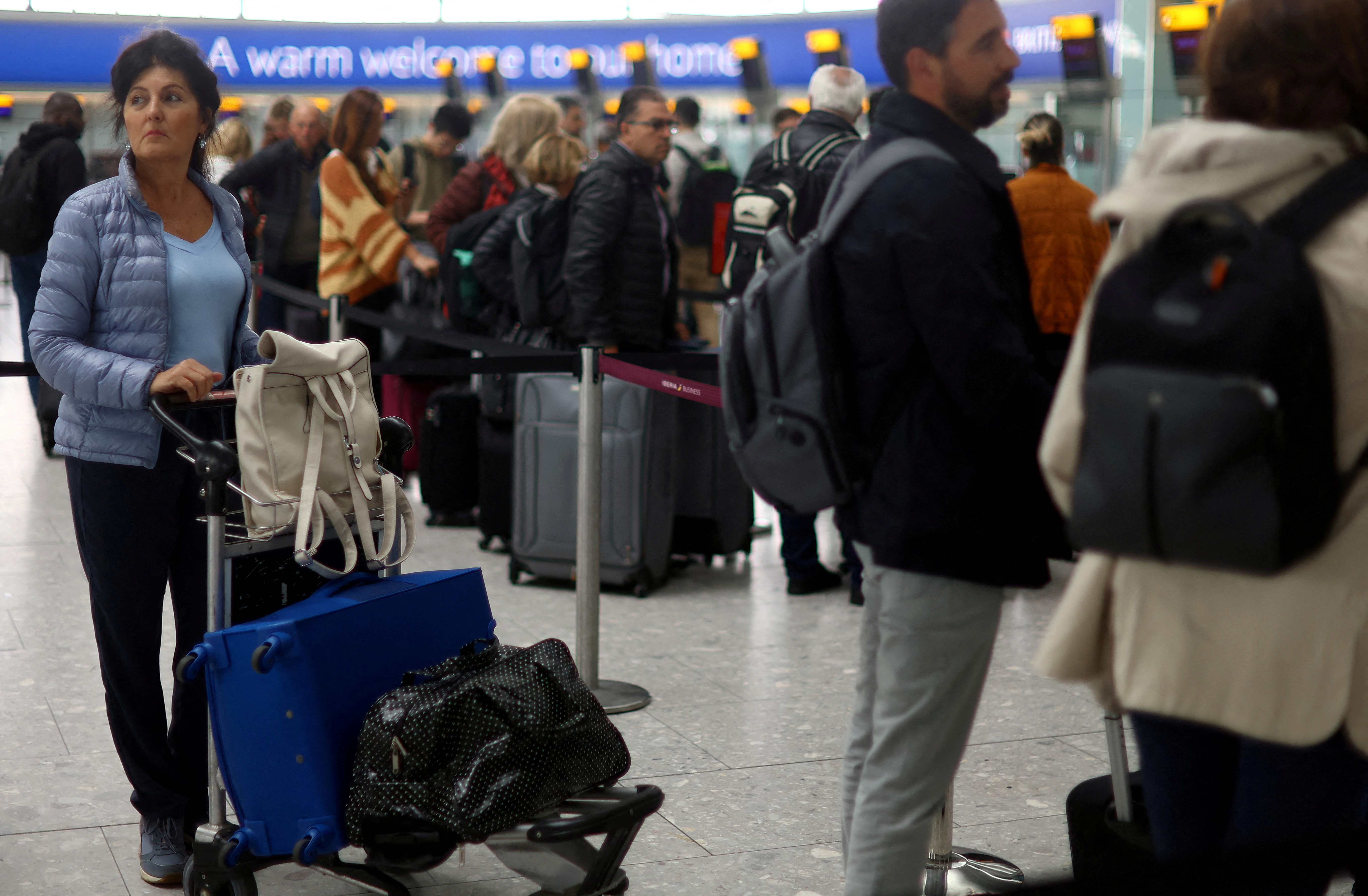 Passengers wait at Heathrow Terminal 5 airport