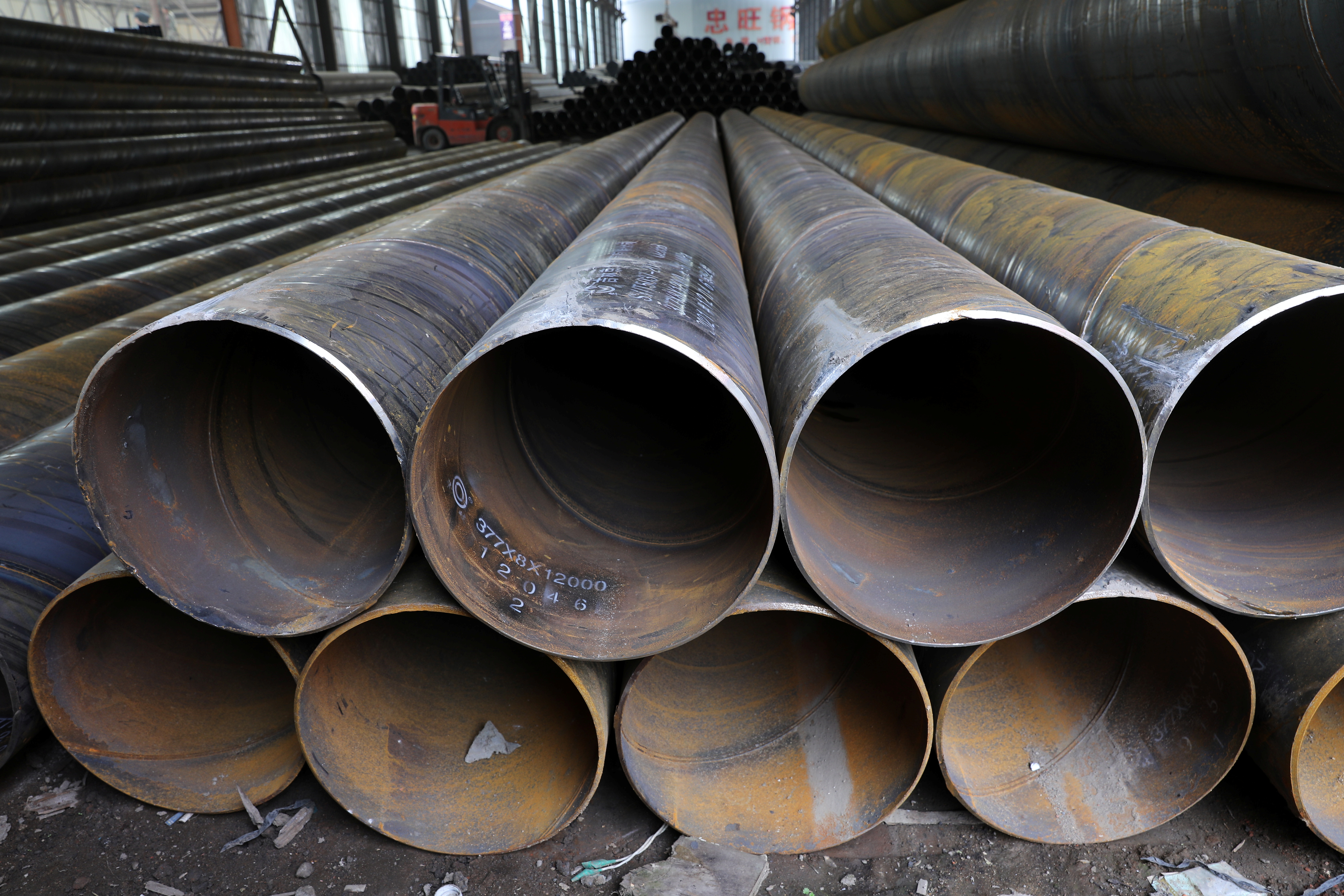 Steel pipes are seen stacked at an industrial park in Shenyang