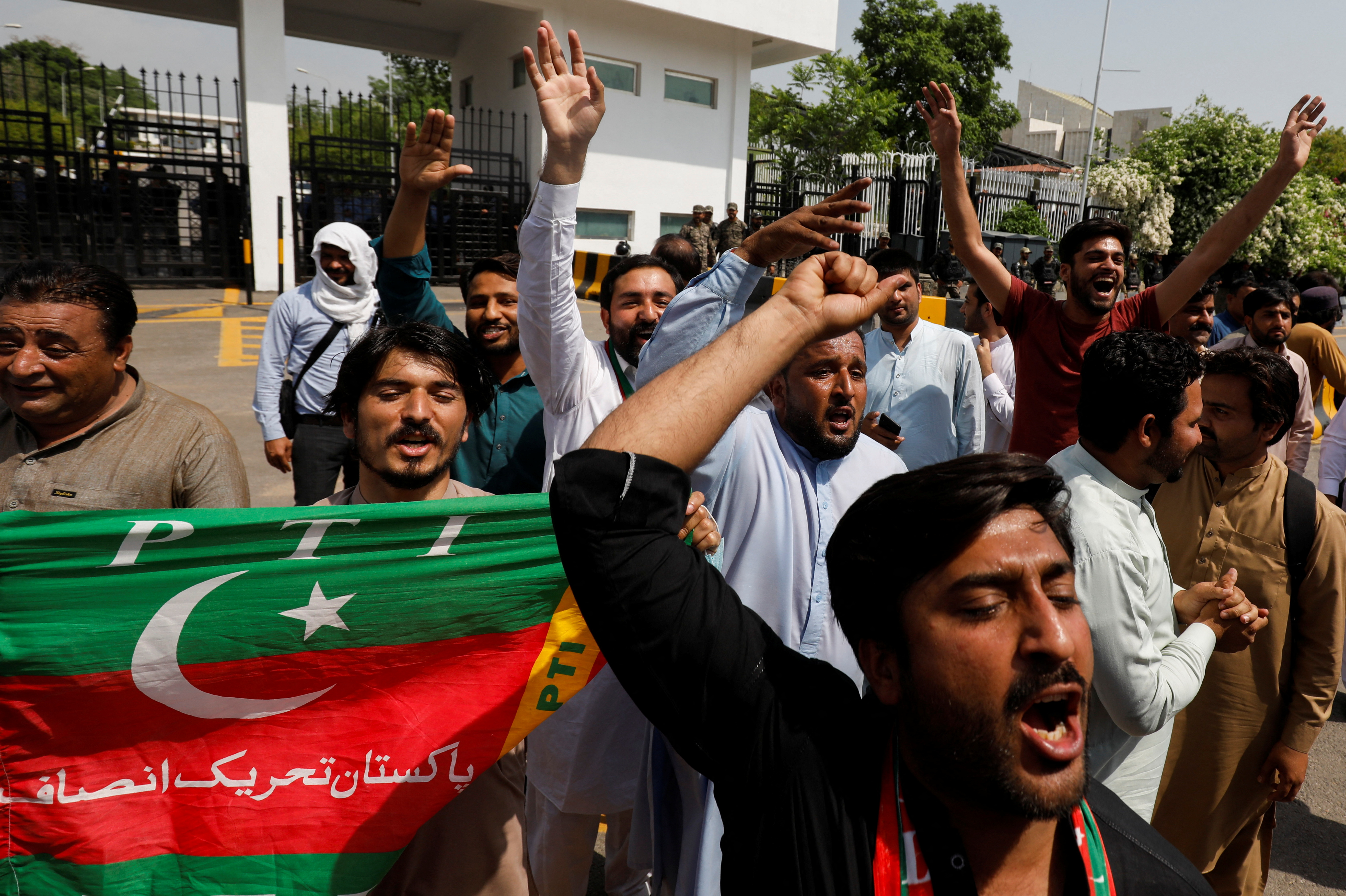Supporters of the Pakistan Tehreek-e-Insaf (PTI) political party, chant slogans in support of Pakistani Prime Minister Imran Khan, outside parliament building Islamabad,