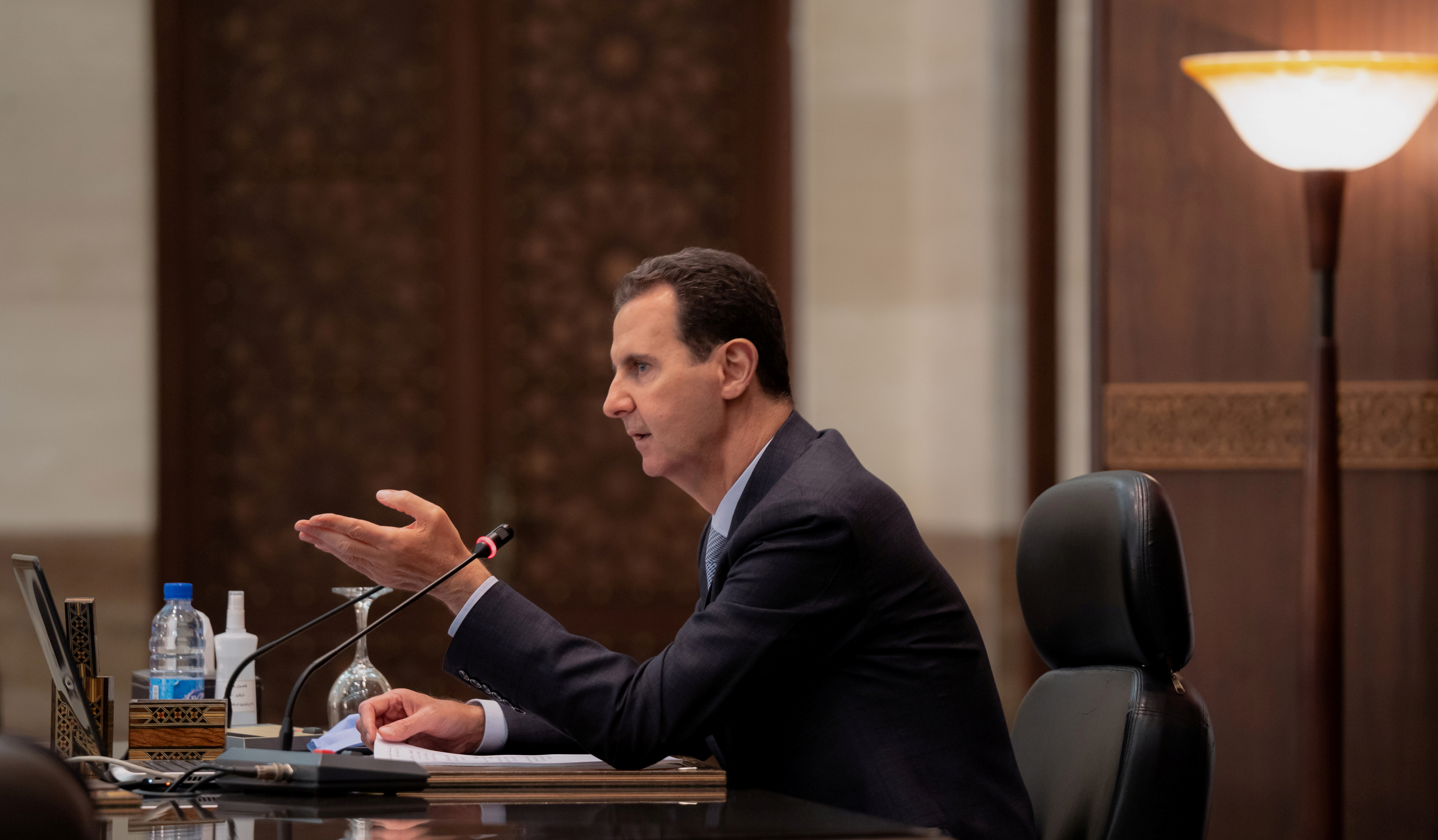 Syrian President Bashar al-Assad speaks at a meeting of his cabinet in Damascus, Syria, in this handout picture released by SANA on March 30, 2021. SANA/Handout via REUTERS