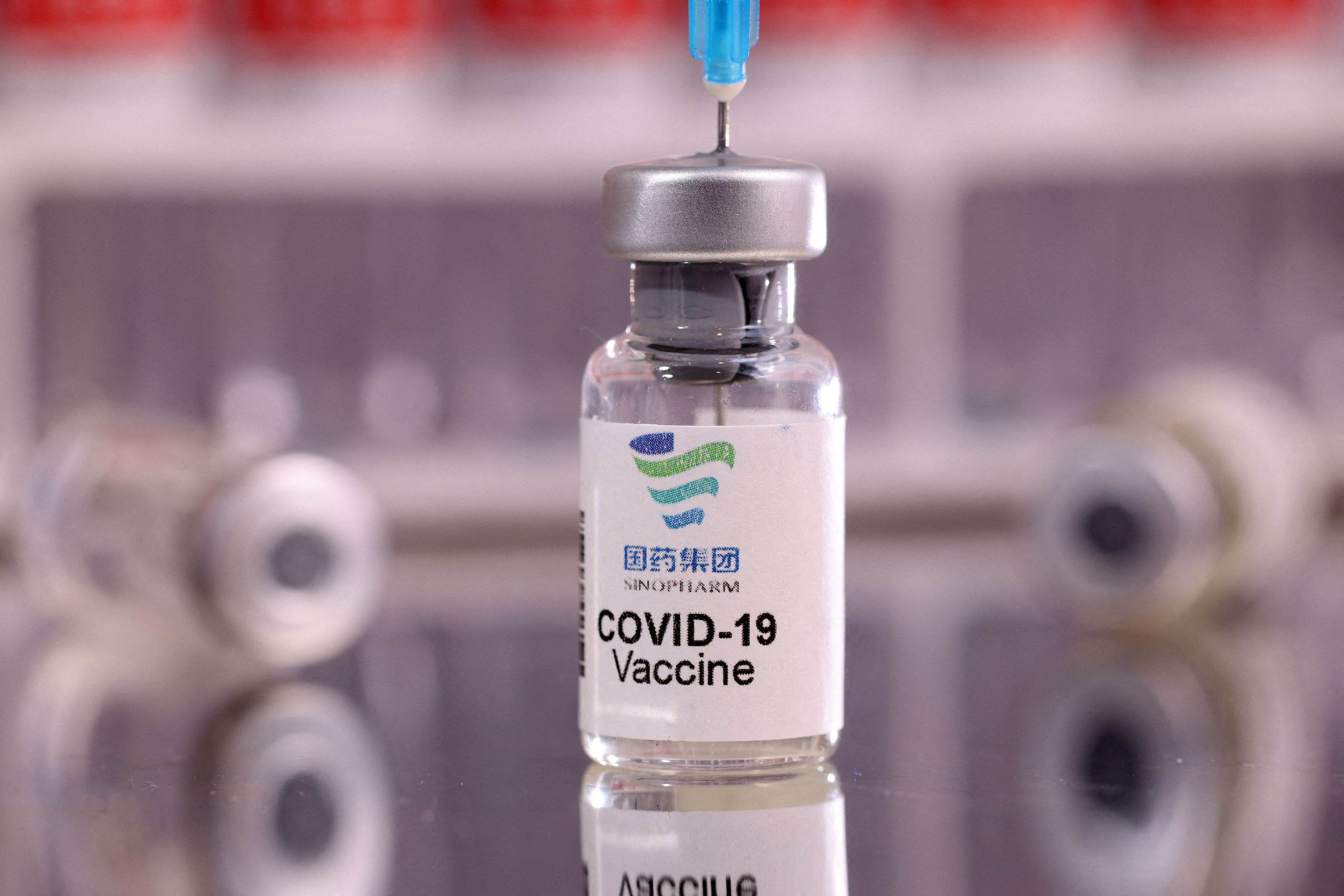 Illustration shows vial labelled "Sinopharm COVID-19 Vaccine\