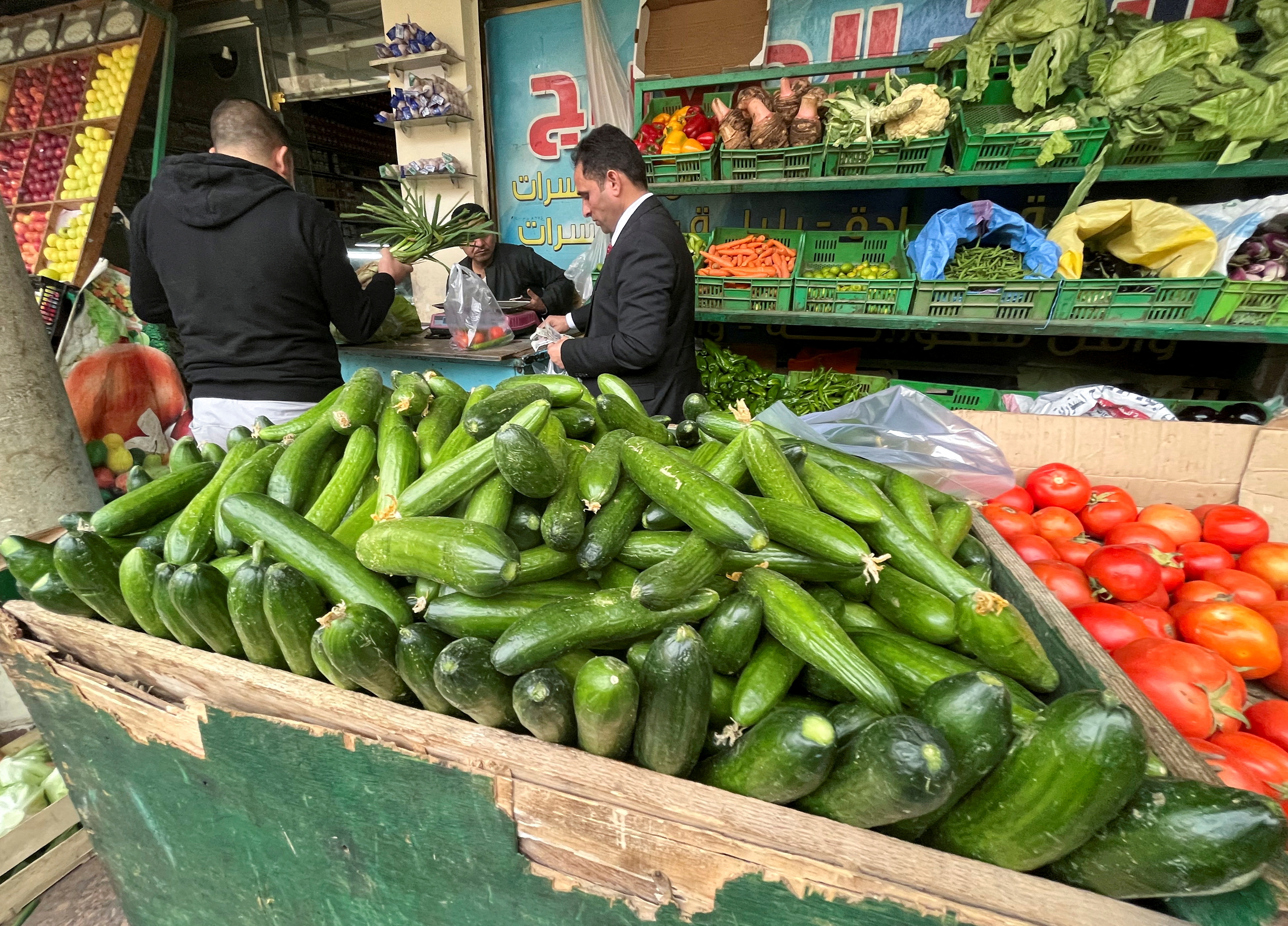 Egyptians buy vegetables at a market in Maadi, a suburb of Cairo