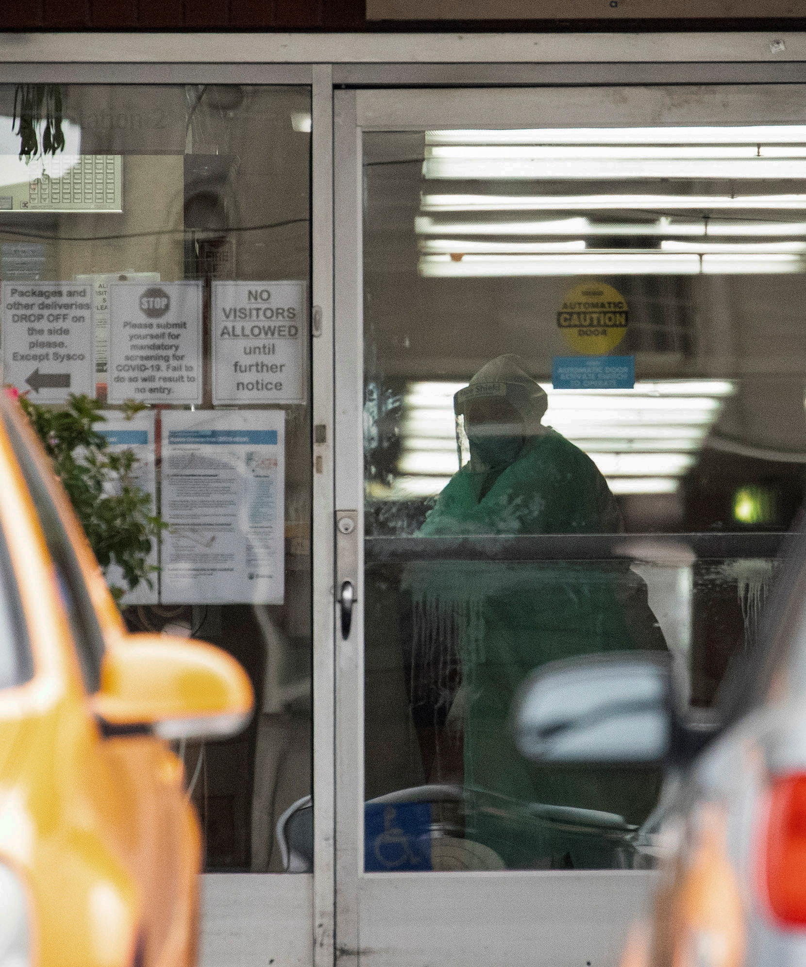 A person in protective gear is pictured inside the Brier Oak on Sunset nursing home, which had 62 staff and 80 residents test positive for the coronavirus disease (COVID-19), according to the California Department of Public Health, in Los Angeles, California, U.S., April 18, 2020. REUTERS/Mario Anzuoni