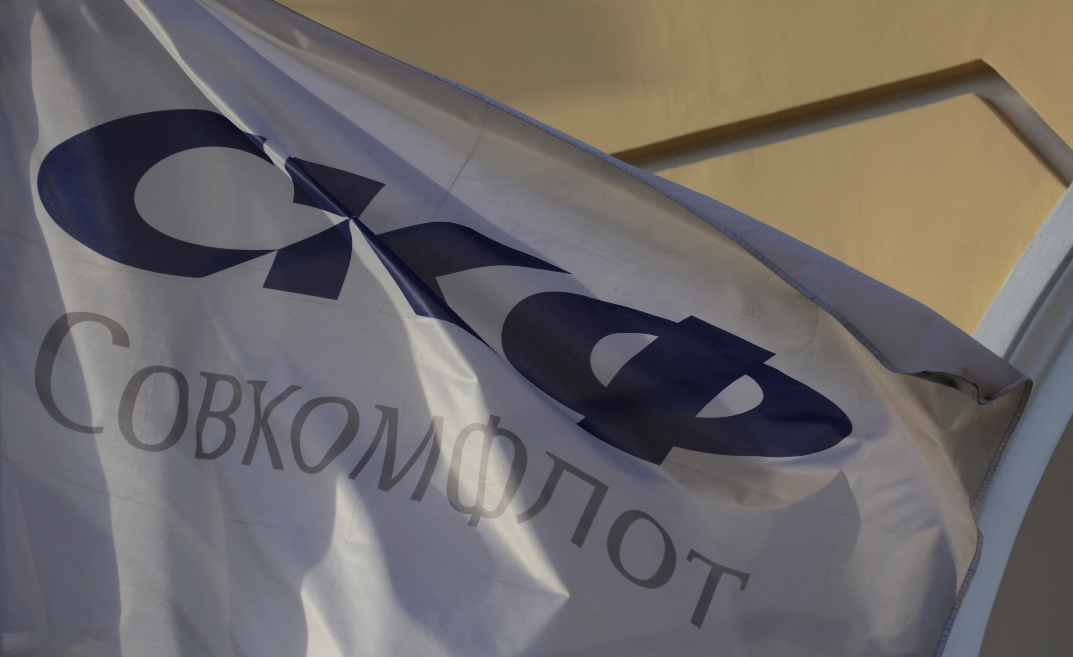 A flag depicting the logo of the Russian state-owned shipping conglomerate Sovcomflot flies outside the company's hearquarters in St. Petersburg