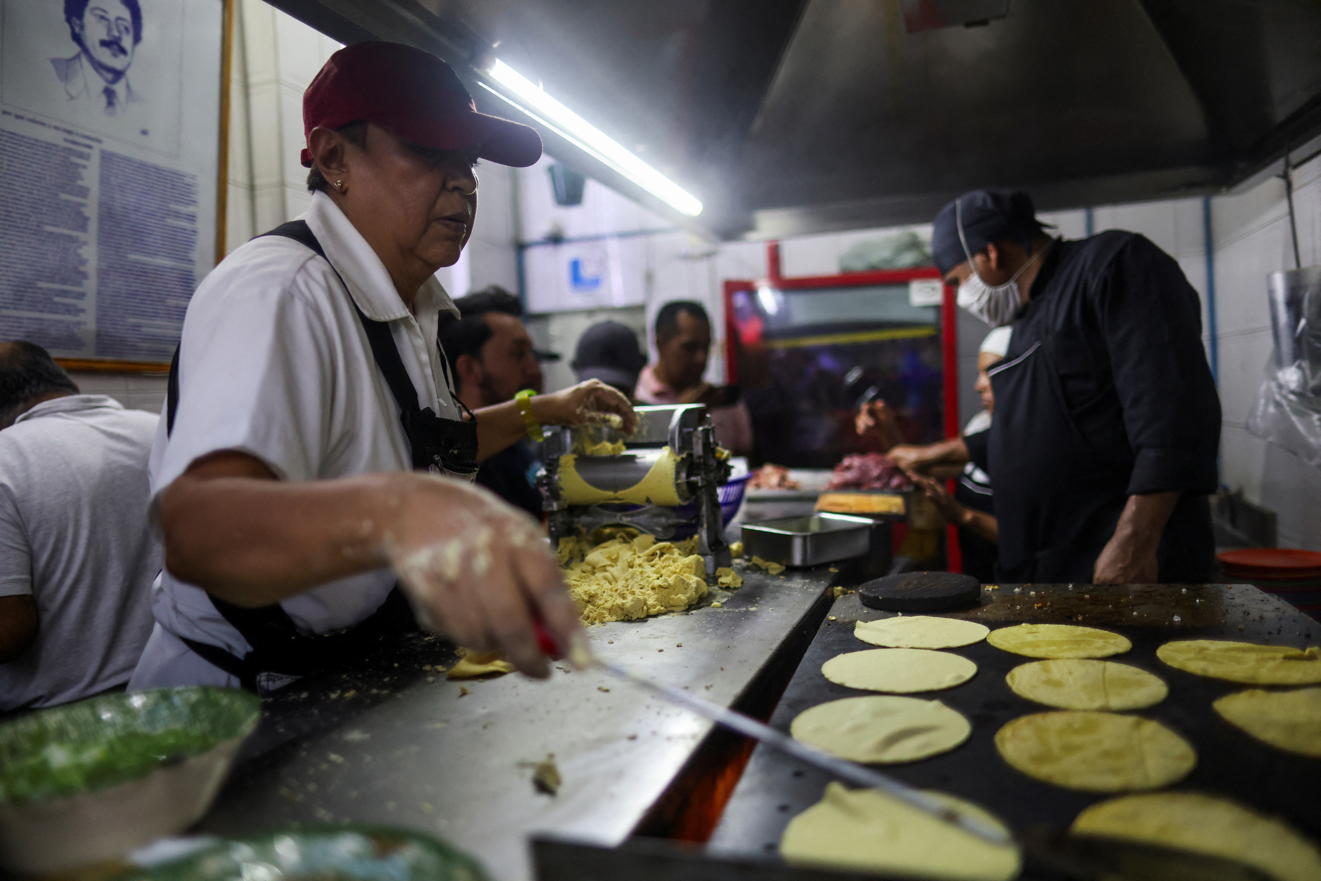 A woman makes tortillas for tacos at the Michelin-starred Taqueria El Califa de Leon, in Mexico City