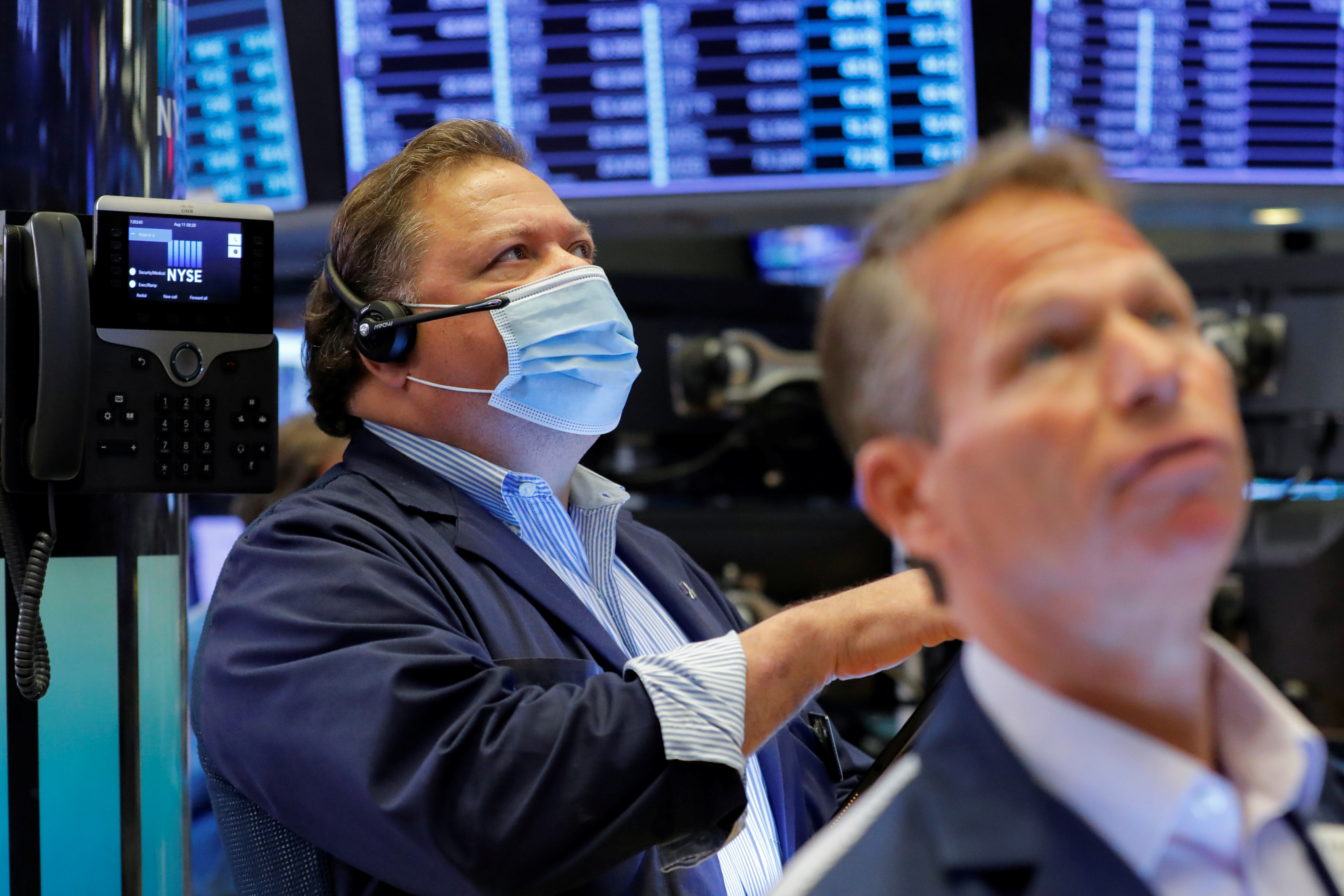 Traders work on the trading floor at the New York Stock Exchange (NYSE) in Manhattan, New York City, U.S., August 11, 2021. REUTERS/Andrew Kelly