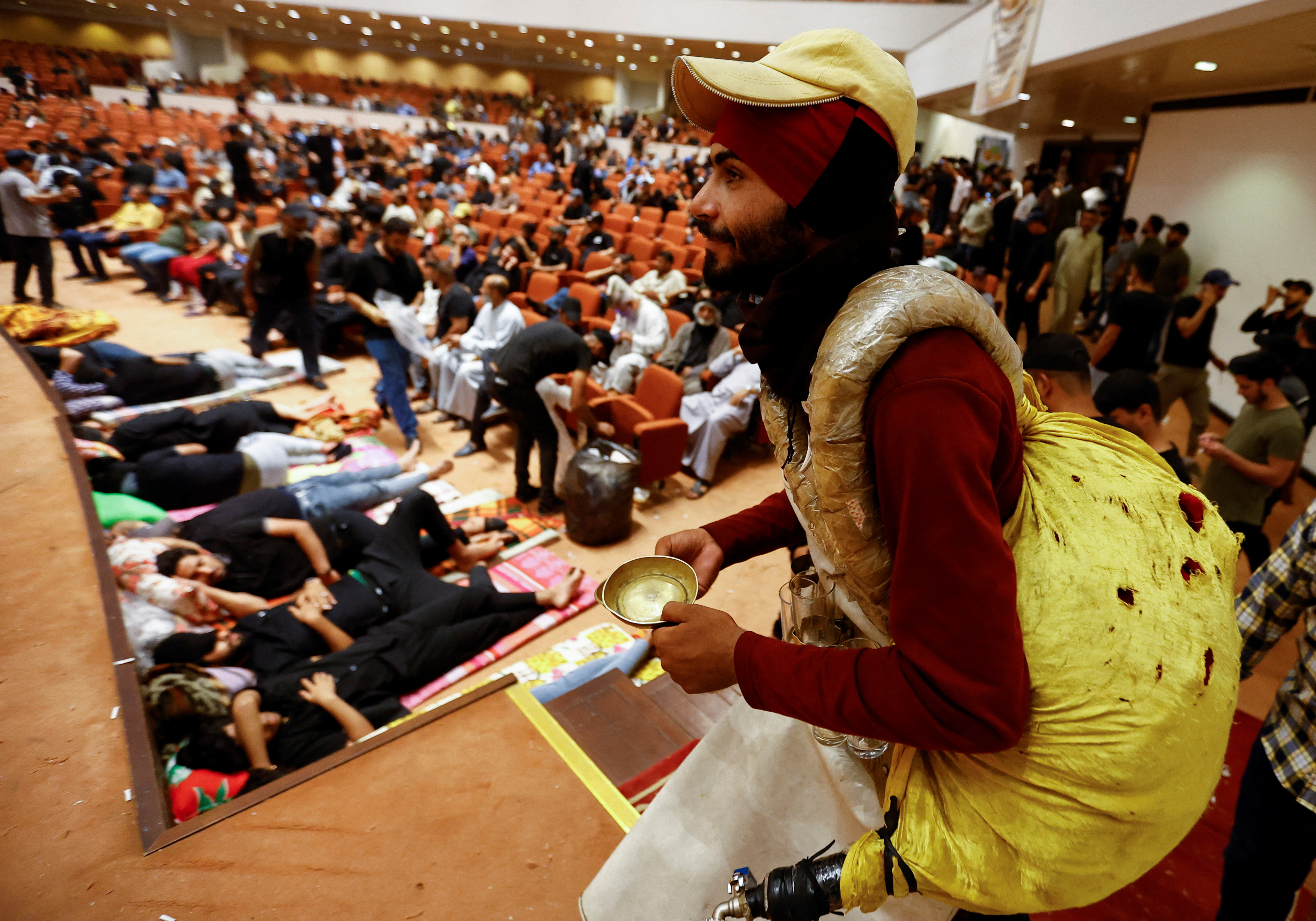 An Iraqi peddler sells juice as supporters of Iraqi Shi'ite cleric Muqtada al-Sadr gather during a sit-in, inside the parliament building amid political crises in Baghdad