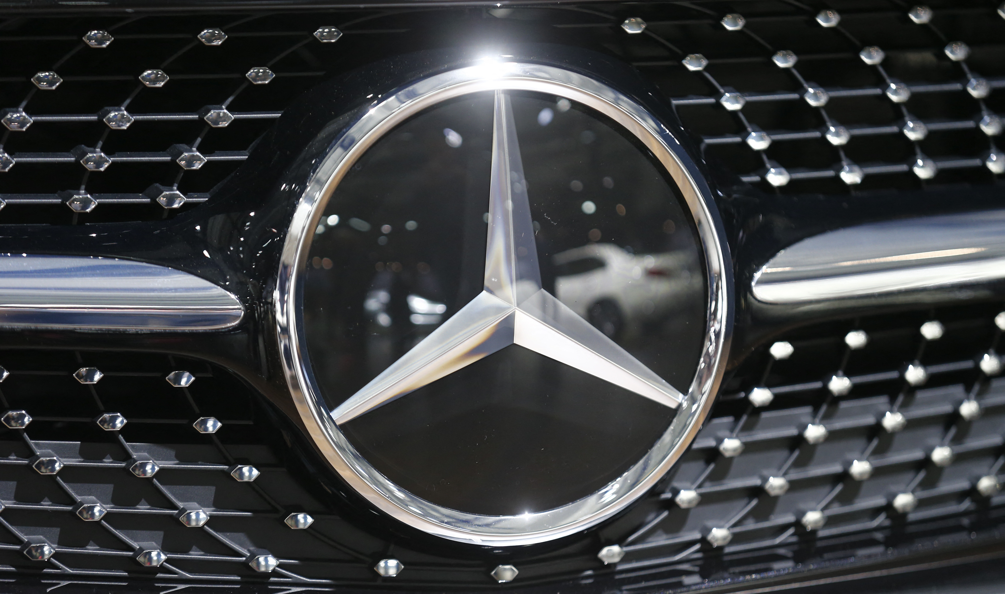 The logo of Mercedes-Benz is pictured on a car prior to the Daimler annual shareholder meeting in Berlin
