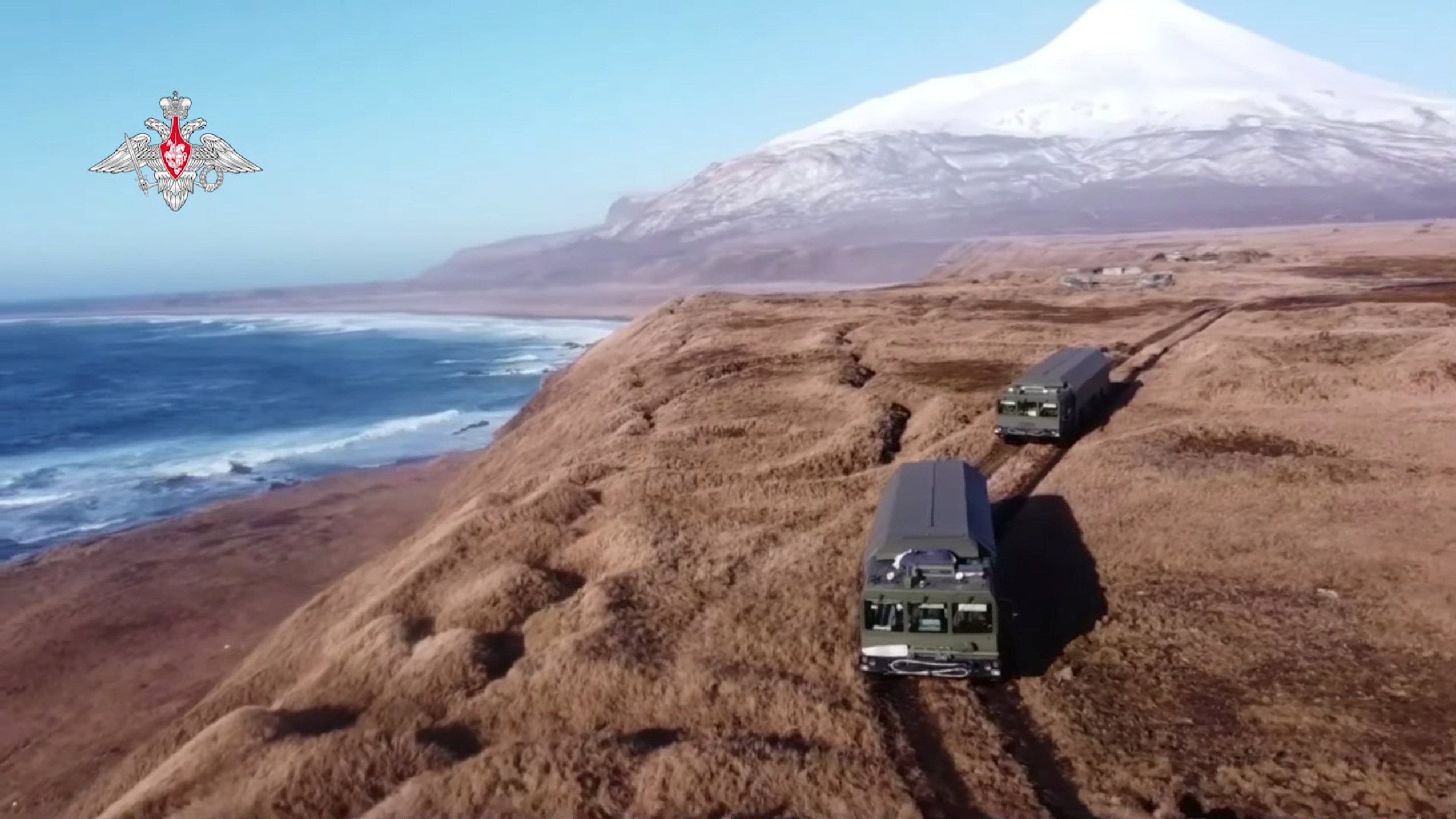 Russia's carriers of the Bastion coastal missile defence system drive on the remote Matua island, which is part the Kuril island chain also known as the Northern Territories in Japan, in the Pacific, in this still image taken from video released by the Russian Defence Ministry December 2, 2021. Russian Defence Ministry/Handout via REUTERS  