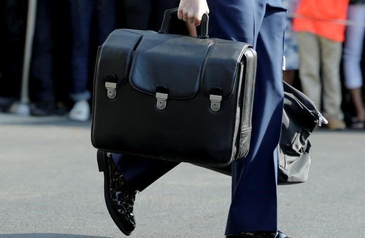 A military aide carries a briefcase containing nuclear codes