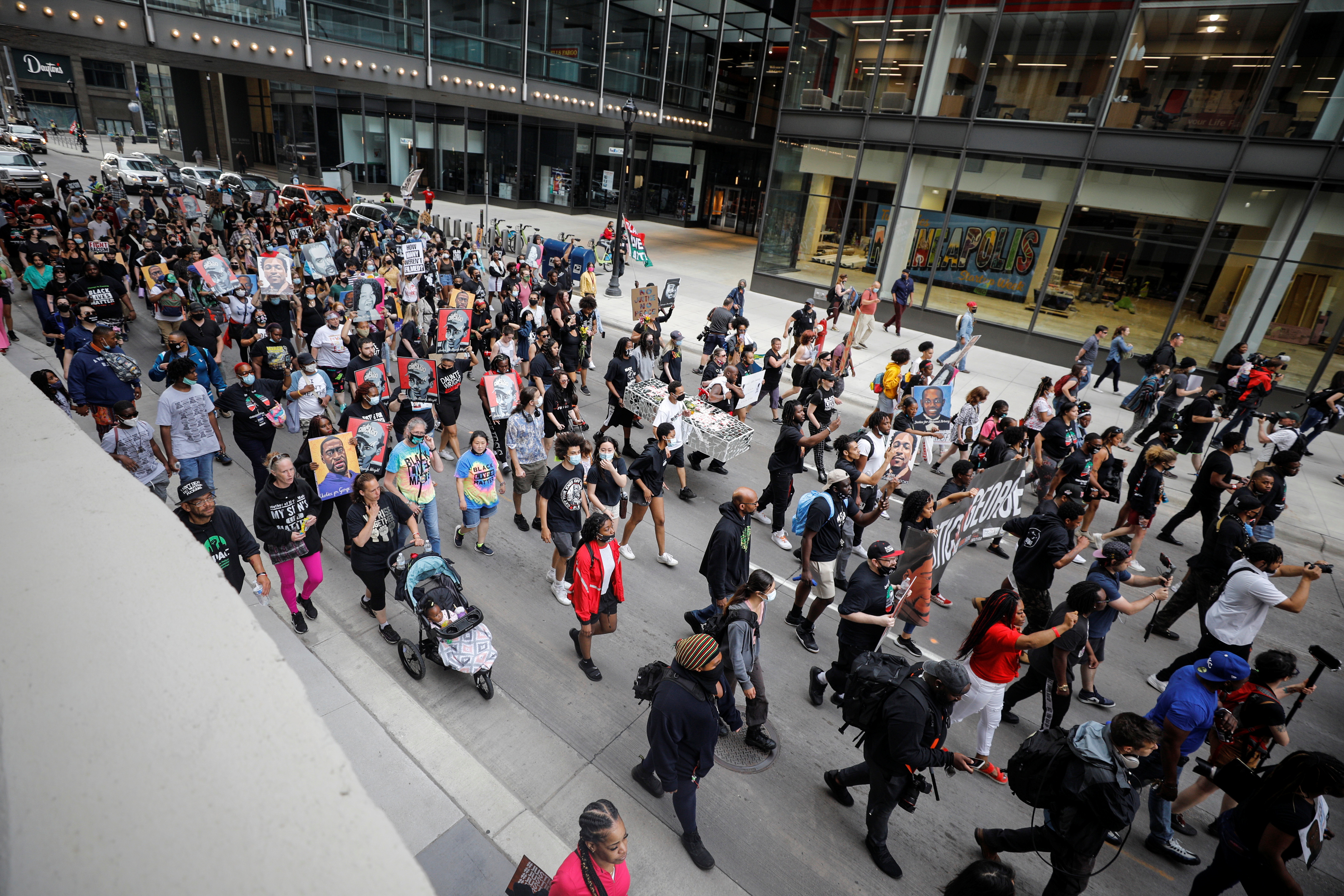People march during the "One Year, What's Changed?" rally hosted by the George Floyd Global Memorial to commemorate the first anniversary of his death, in Minneapolis, Minnesota, U.S. May 23, 2021. REUTERS/Nicholas Pfosi