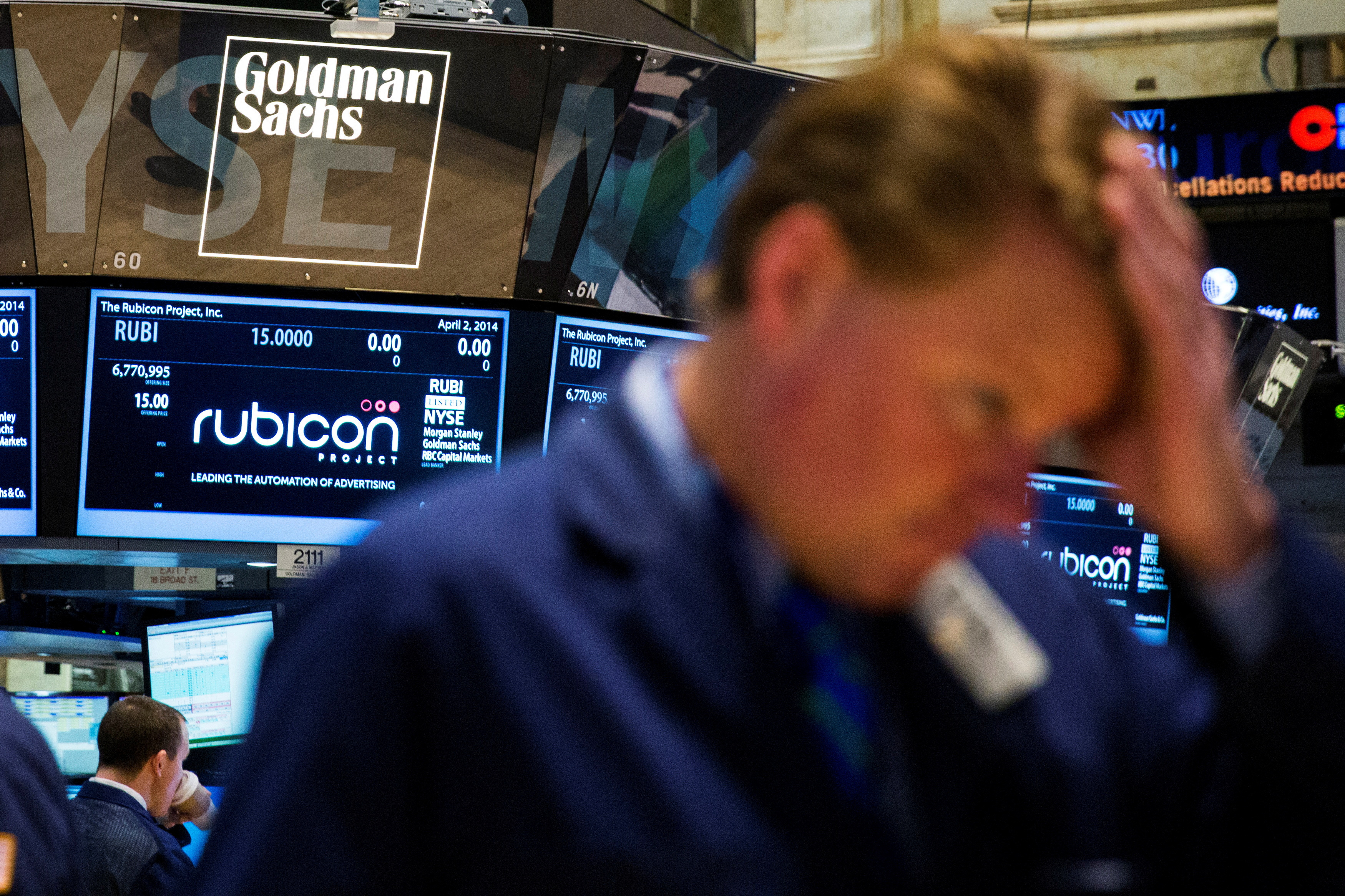 Goldman Sachs logo above a trader on the floor of the New York Stock Exchange shortly after the opening bell in the Manhattan borough of New York