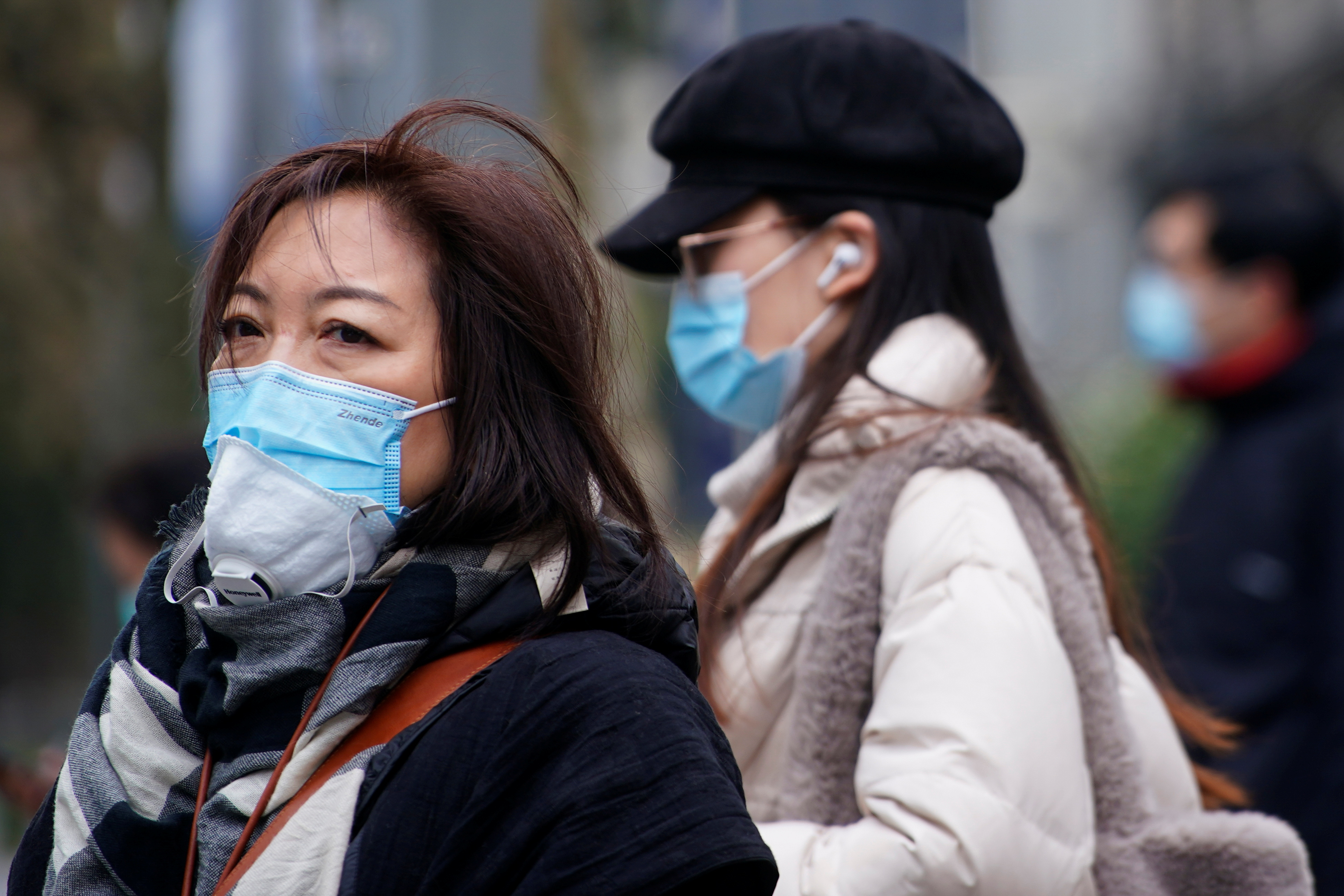People wearing face masks are seen on a street following the coronavirus disease (COVID-19) outbreak, in Shanghai
