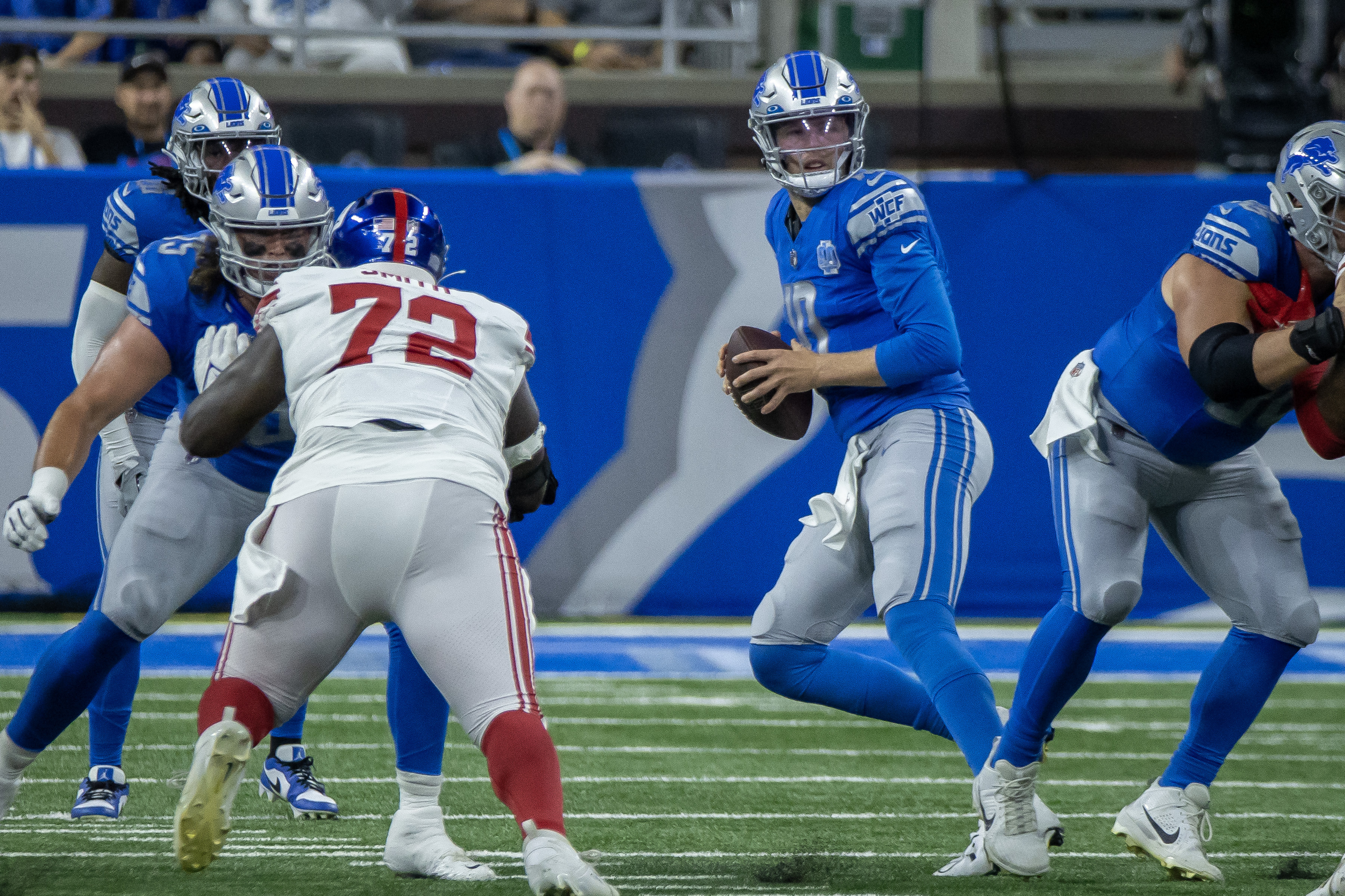 Detroit Lions quarterback Adrian Martinez (18) avoids New York Giants  linebacker Habakkuk Baldonado (45) while carrying the ball during the  second half of an NFL preseason football game, Friday, Aug. 11, 2023