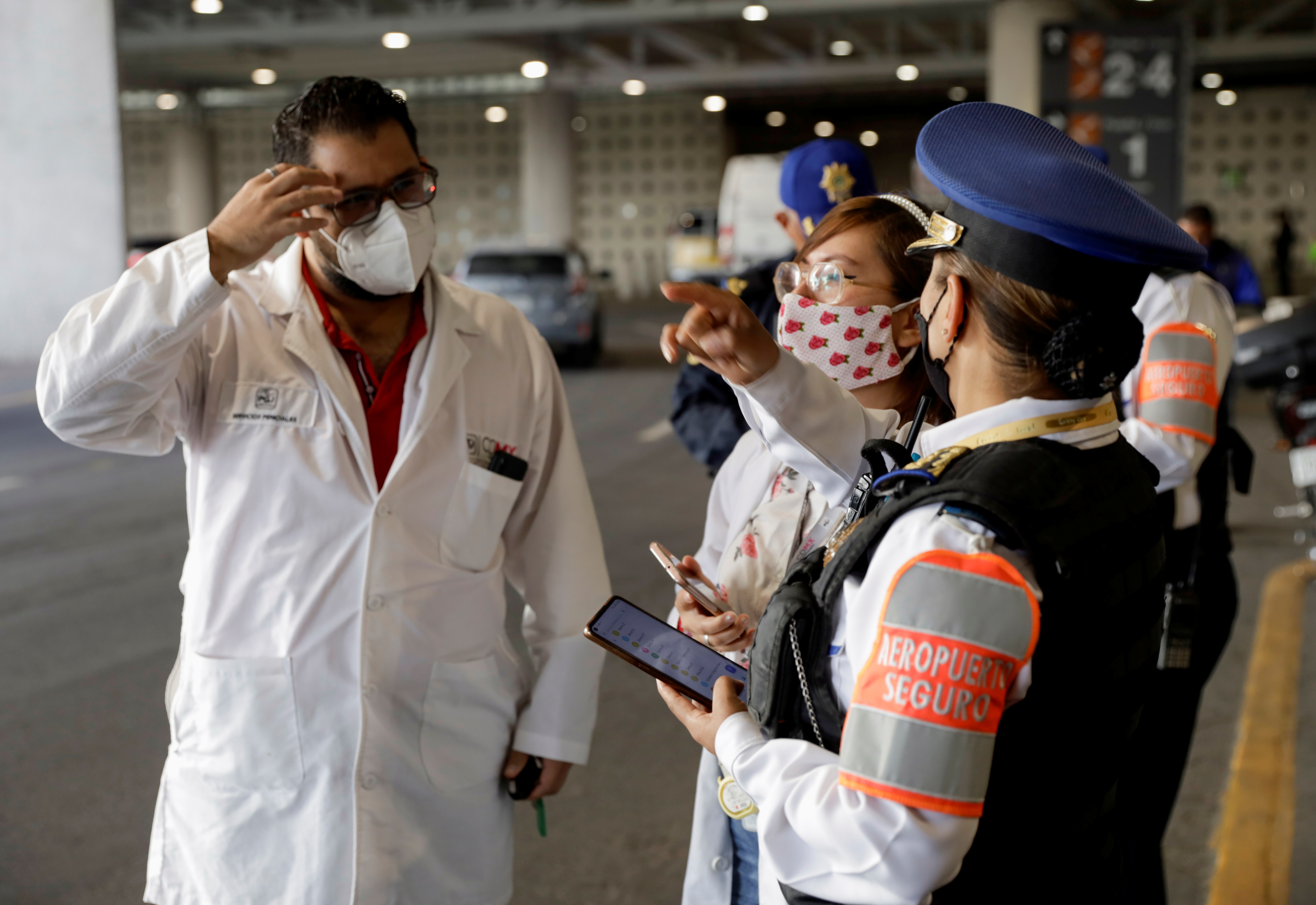 Agents of the city's prosecutors office and police officers collect information outside the airport, in Mexico City