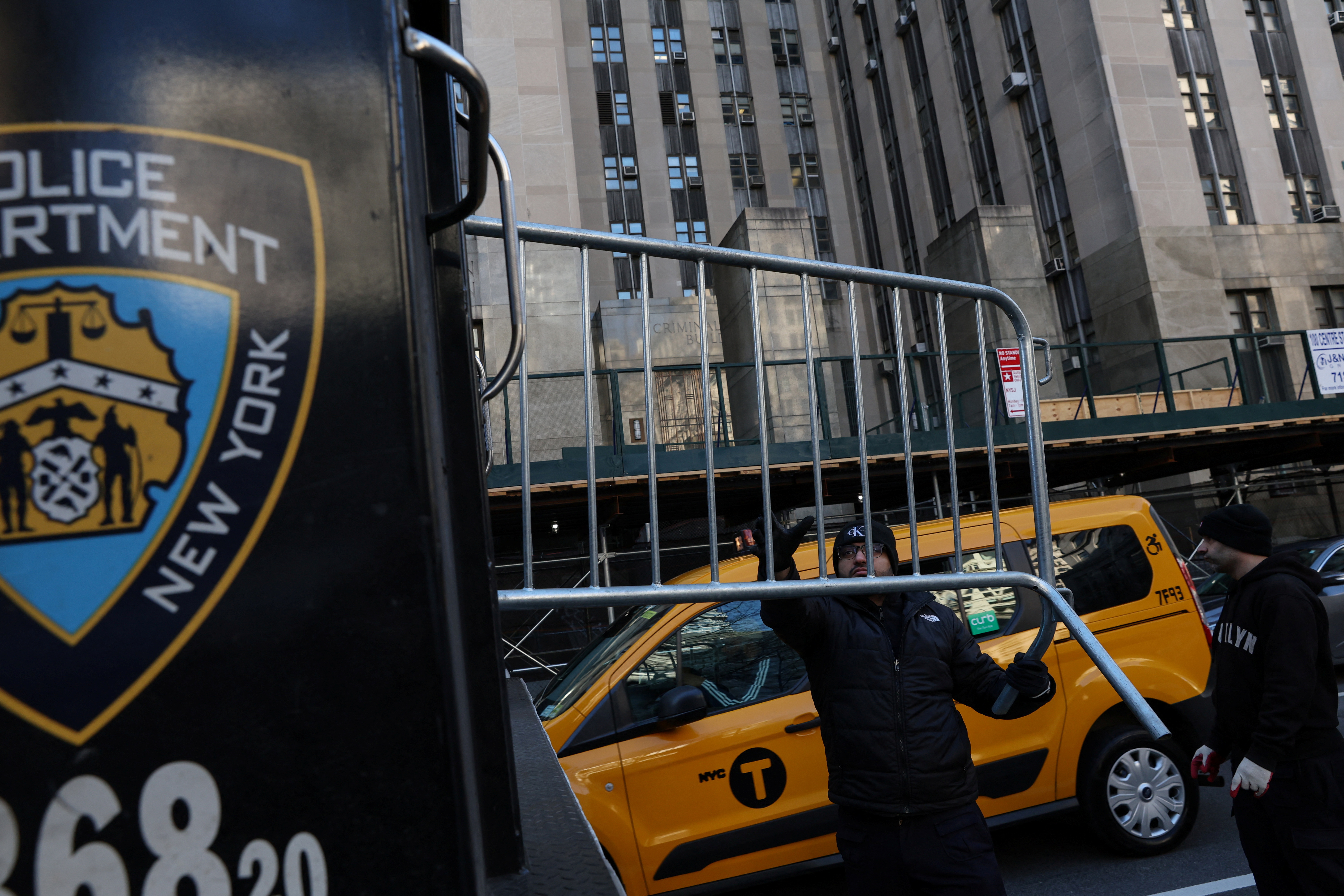 Men set up NYPD barricades outside Manhattan Criminal Court in New York City