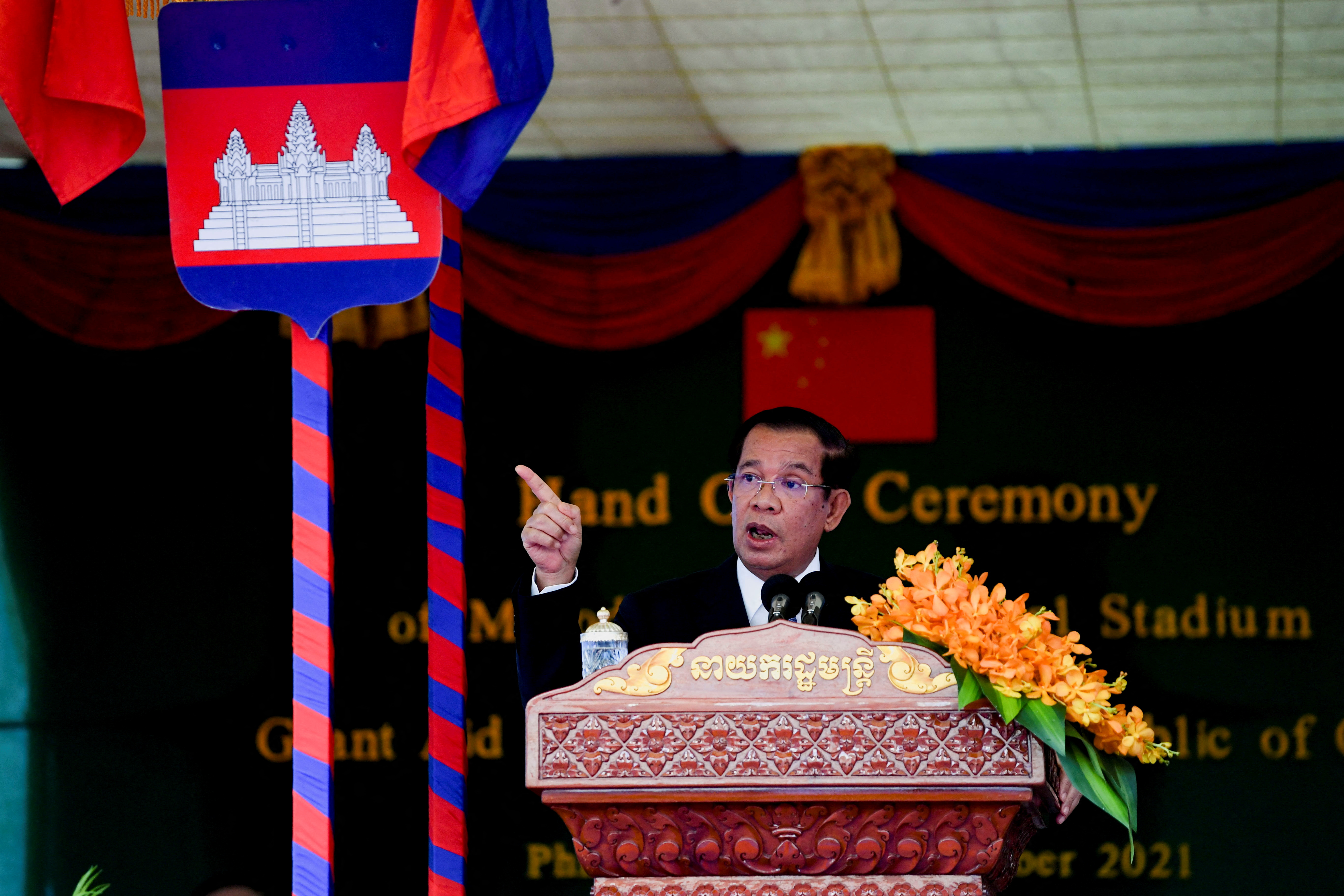 Cambodian Prime Minister Hun Sen and China's State Councillor and Foreign Minister Wang Yi attend a handover ceremony at the Morodok Techo National Stadium, in Phnom Penh