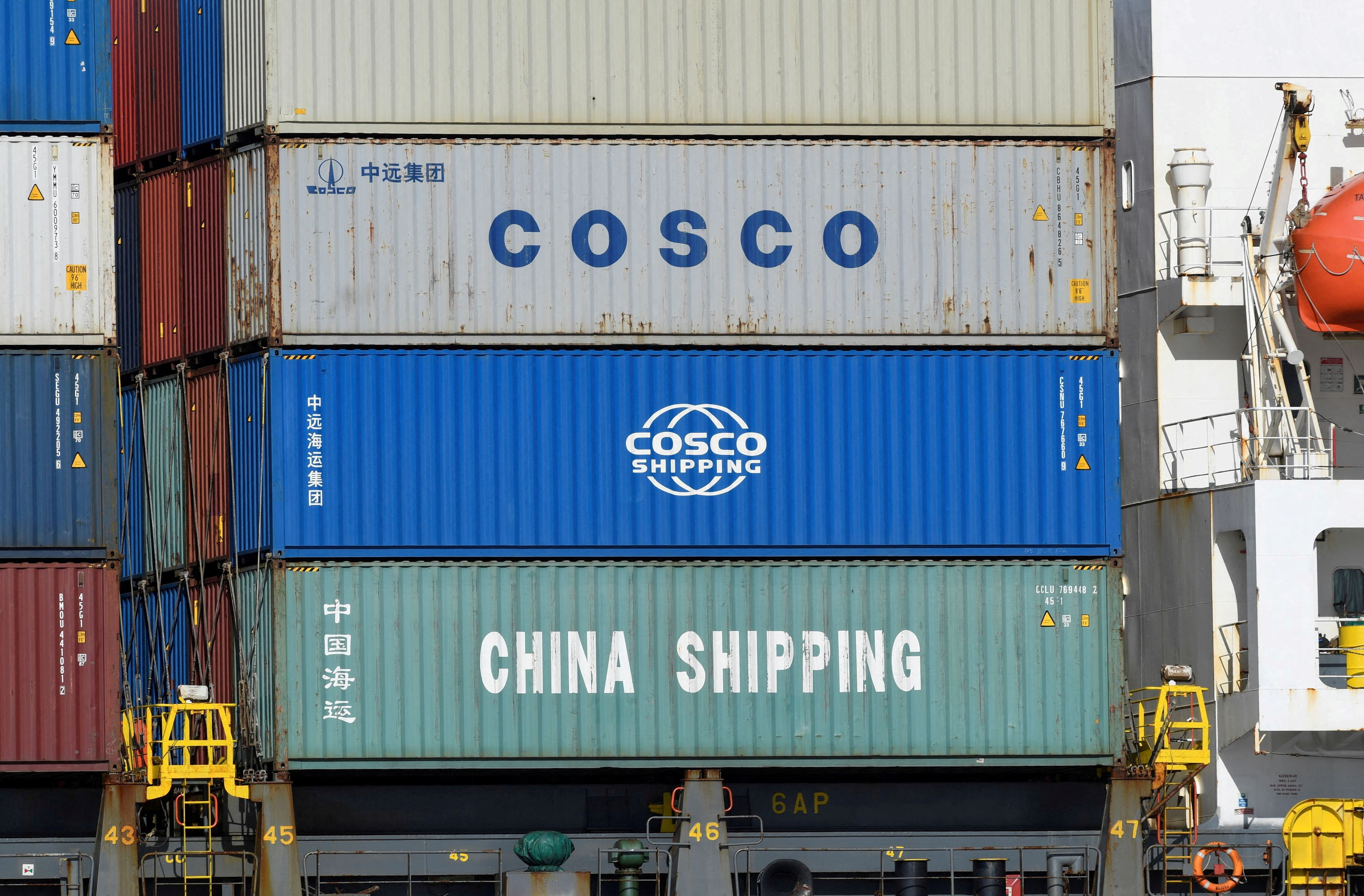 Containers of Chinese companies China Shipping and COSCO (China Ocean Shipping Company) are loaded on a container as it is leaving the port in Hamburg
