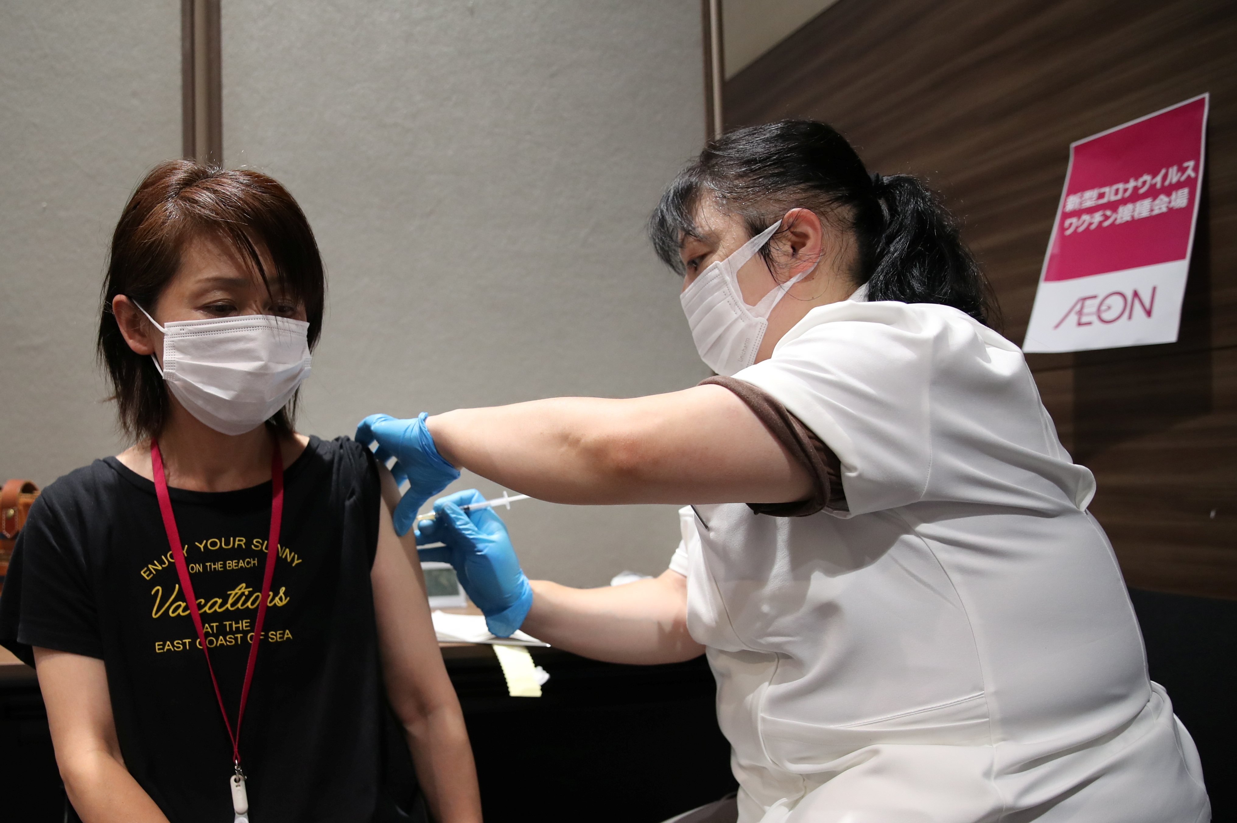A staff of Japan's supermarket group Aeon receives a dose of the Moderna coronavirus disease (COVID-19) vaccine at the company's shopping mall in Chiba
