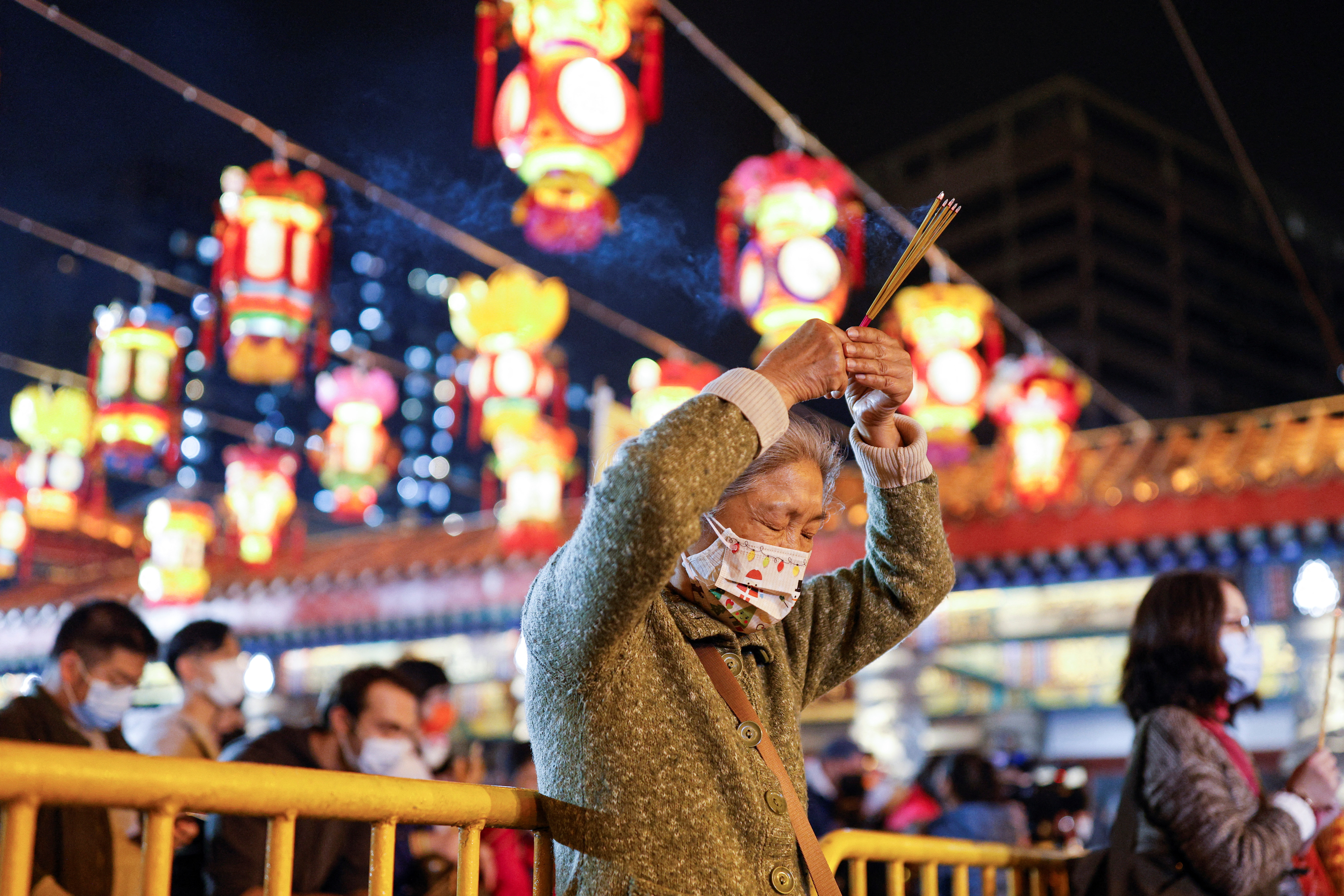 Chinese pray for health in Lunar New Year as Covid death toll rises