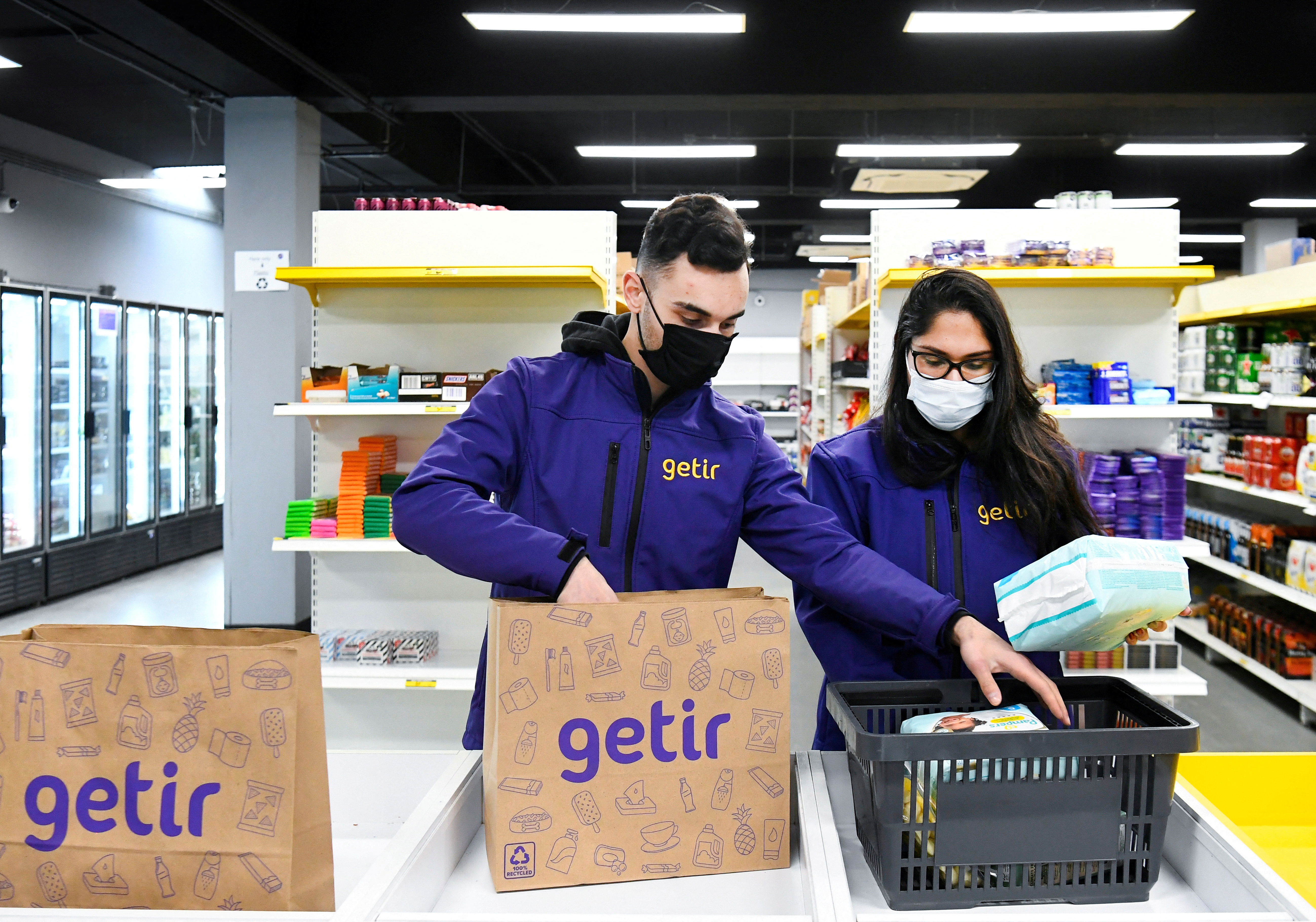 Order pickers work at a dark store of the fast grocery deliverer Getir