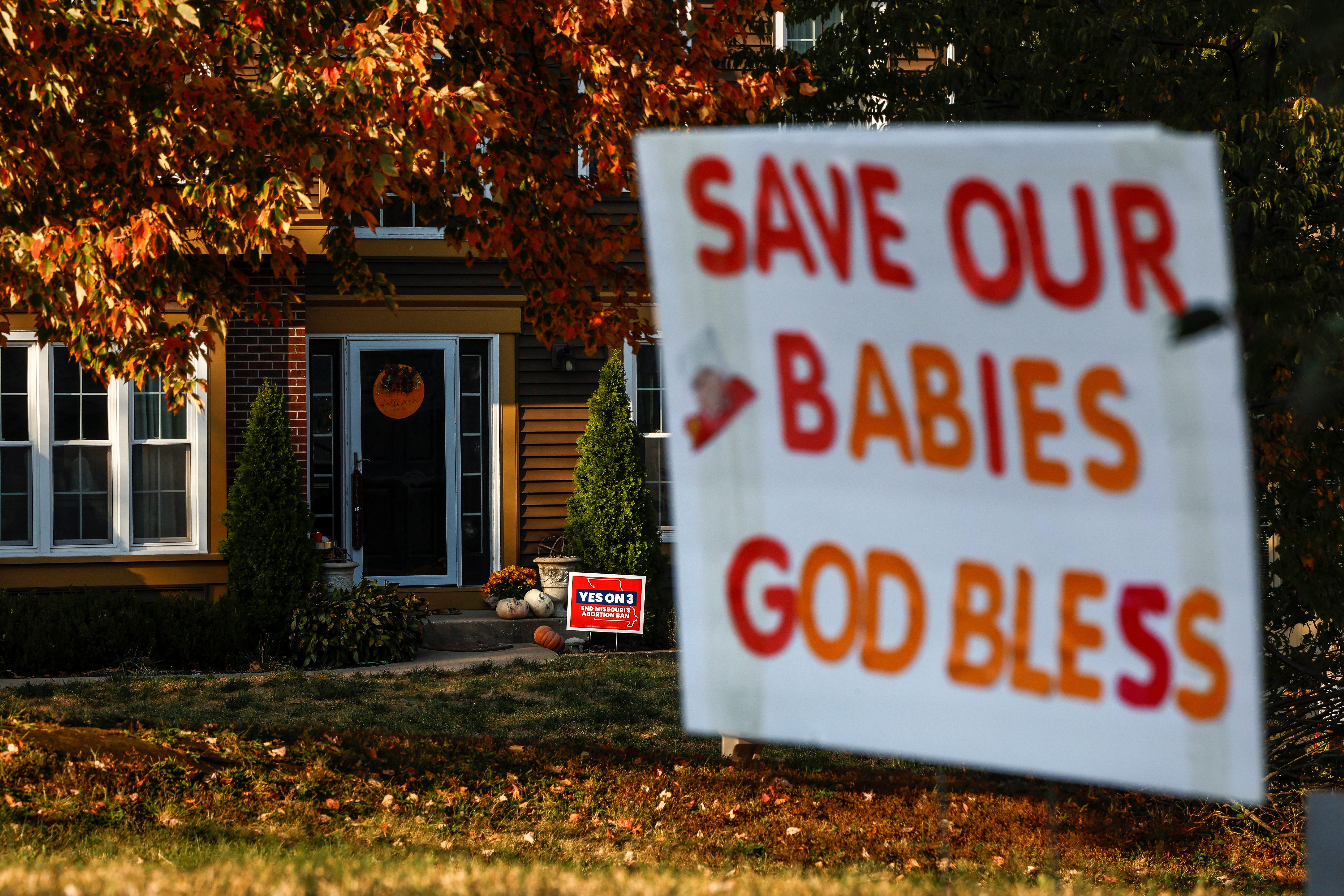 Competing yard signs for and against Amendment 3, a measure that would establish a constitutional right to abortion dot neighborhoods in Missouri