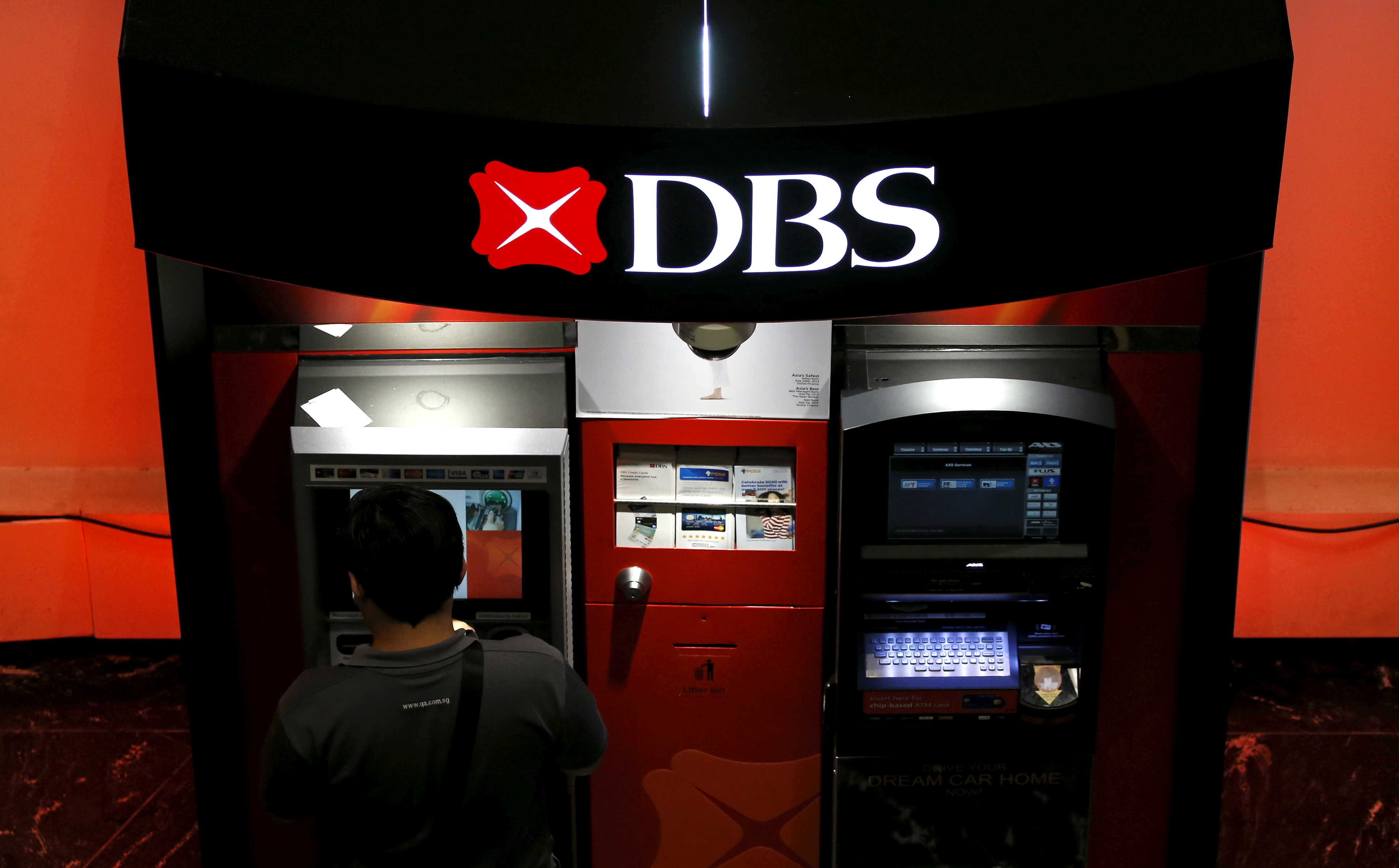 A man uses a DBS automated teller machine in Singapore