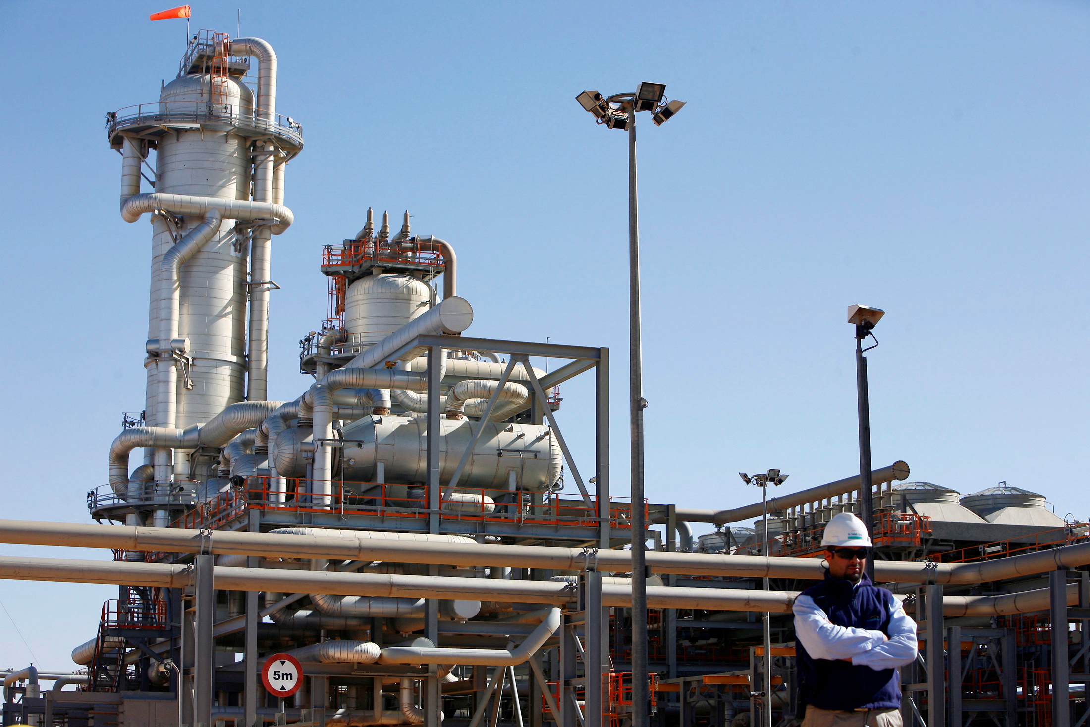 A technician stands at the Krechba gas treatment plant