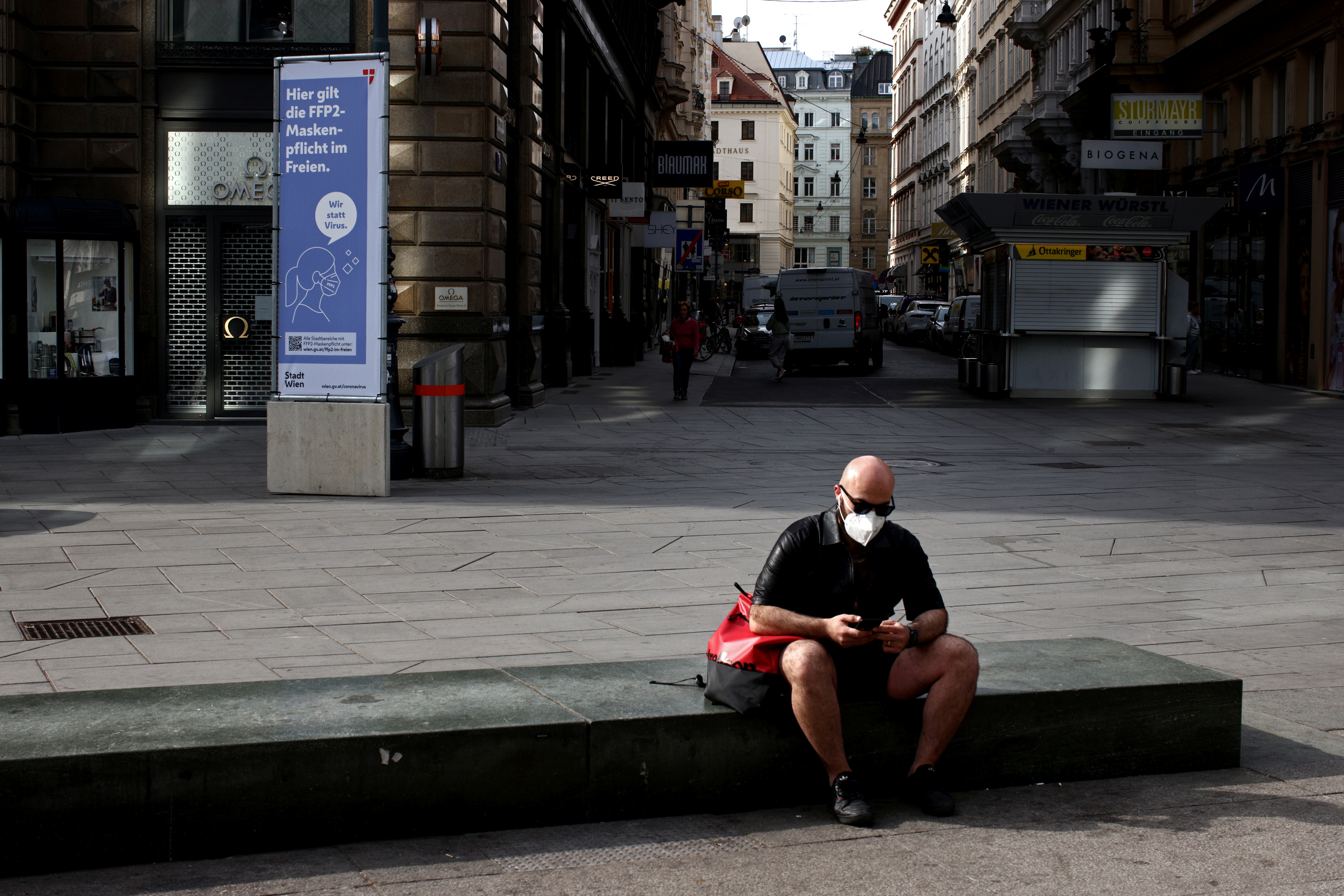 A person wearing an FFP2 mask sits at St. Stephen's square amid the coronavirus disease (COVID-19) outbreak in Vienna, Austria, April 1, 2021. REUTERS/Lisi Niesner